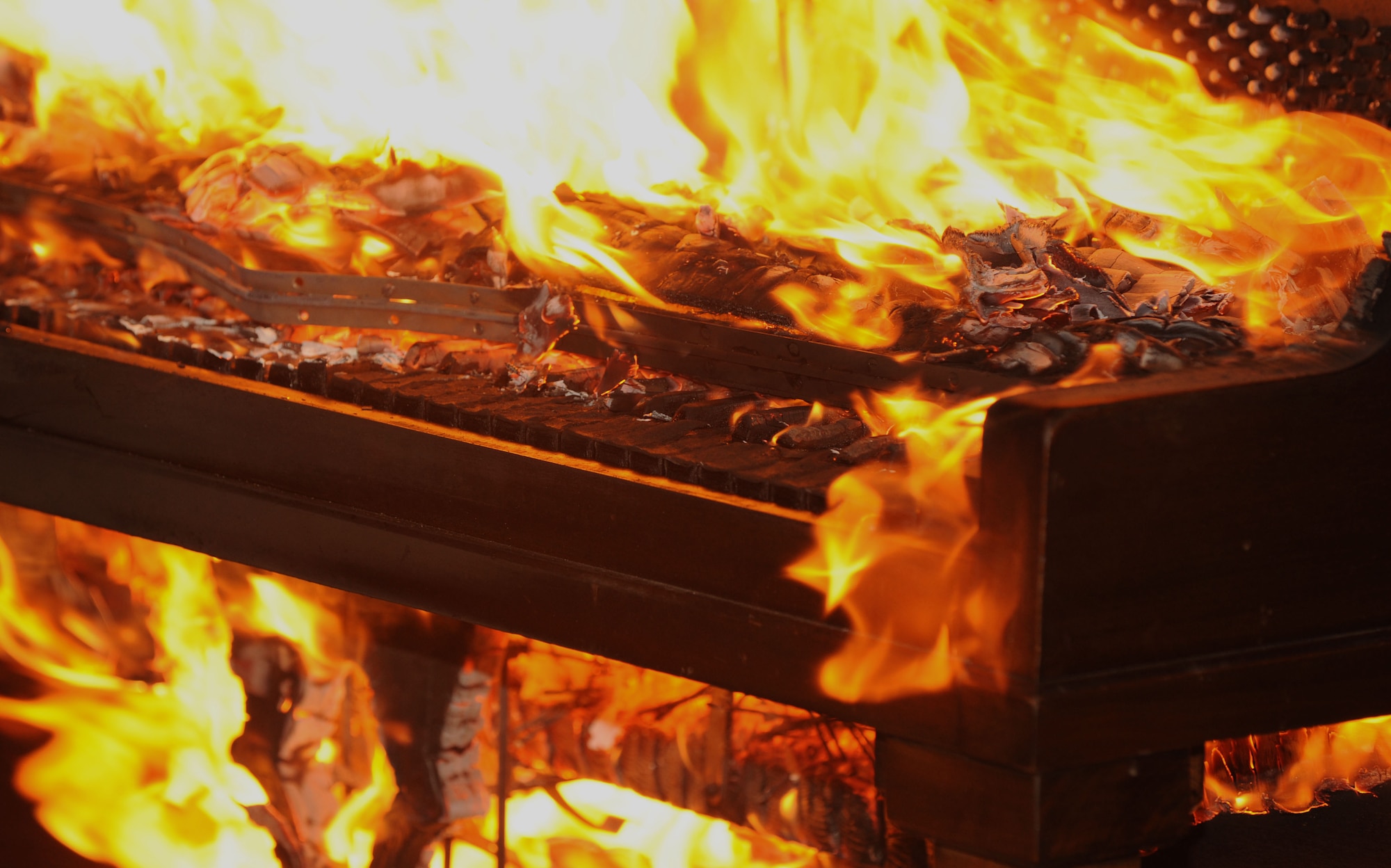 The 94th Fighter Squadron commemorates its 94th anniversary by burning a piano in a traditional ceremony at Langley Air Force Base, Va., Aug. 19, 2011. The piano burning tradition began with the Royal Air Force during World War II with the Battle of Britain to honor piano-playing comrades who died in action. (U.S. Air Force photo by Airman 1st Class Racheal Watson/Released)
