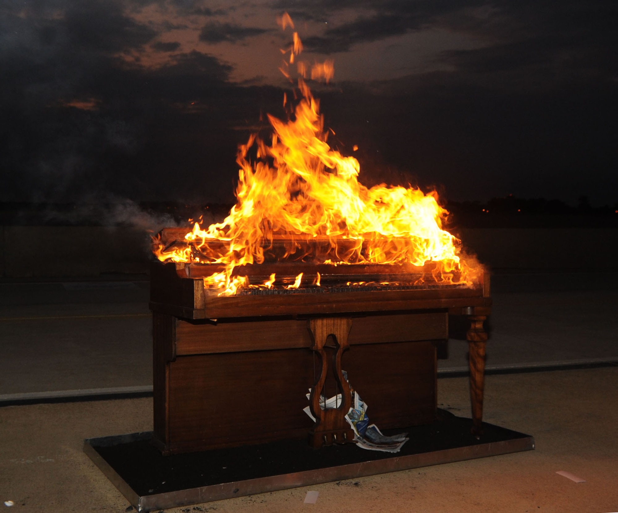 The 94th Fighter Squadron celebrates its 94th anniversary by burning a piano in a traditional ceremony Aug. 19, 2011, at Langley Air Force Base, Va. The ceremony was adopted from the Royal Air Force to celebrate the lives of fallen pilots who played piano during World War II. (U.S. Air Force photo by Airman 1st Class Racheal Watson/Released)
