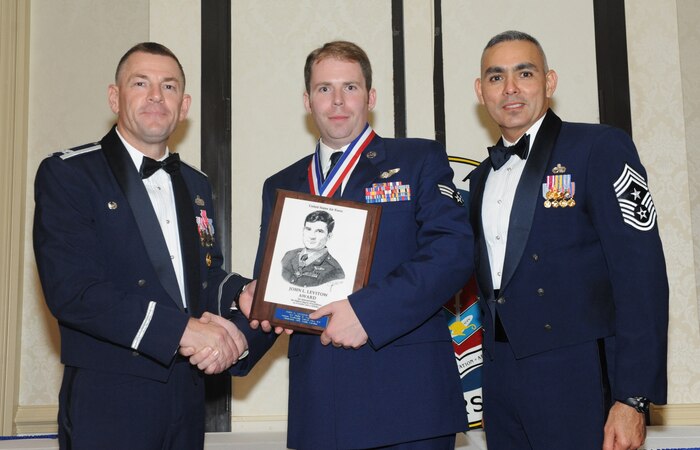 Col. Richard McComb and Chief Master Sgt. Jose LugoSantiago present Senior Airman Philip Consolo the John Levitow award at the Airman Leadership School  Graduation Ceremony at Joint Base Charleston - Air Base Aug. 18.The John Levitow award is presented to the Airman that displays the best overall performance evaluation, peer to staff rating and academic ranking while attending ALS, a six-week course designed to develop Airman into effective leaders and supervisors.
McComb is the JB CHS commander, LugoSantiago is the 628th Airbase Wing command chief and Consolo is a Loadmaster for the 17th Airlift Squardron. (U.S. Air Force photo/Airman 1st Class Ashlee Galloway)  