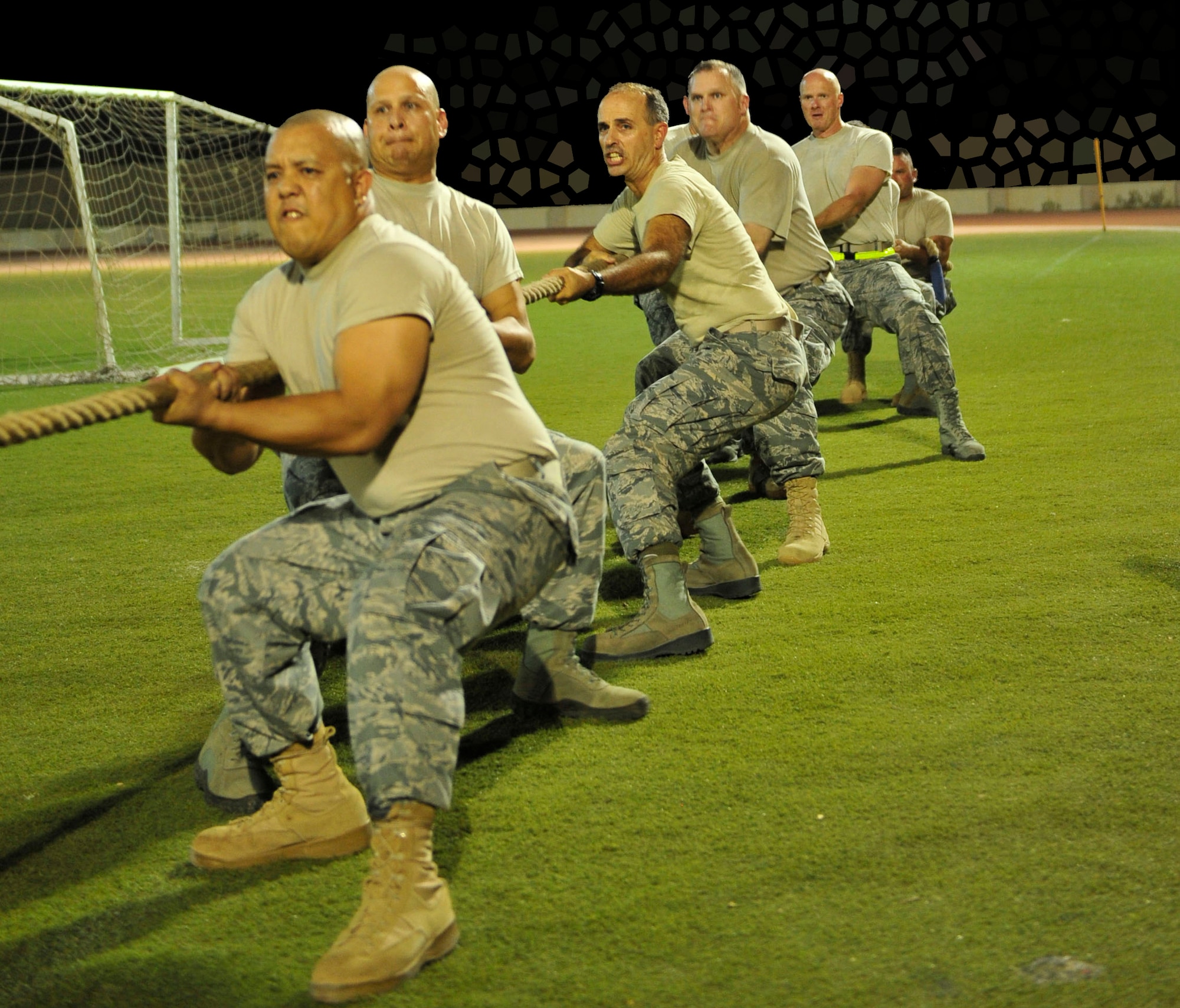 The 380th Air Expeditionary Wing chiefs' group team gets ready to pull against team from 3rd Battalion, 4th Air Defense Regiment of the U.S. Army team during an early match at the Ramadan Games. The chiefs' group team won the tournament with four straight wins. The Ramadan Games is an annual sporting competition put on at an air base in Southwest Asia in which teams from the 380th AEW, the Army's 3-4 ADAR, the French air force and the host nation military compete in events including soccer, volleyball, tug o' war and swimming. (U.S. Air Force illustration/Master Sgt. Chance Babin) 