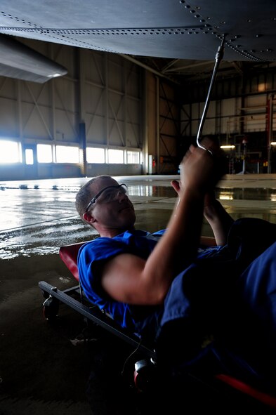 U.S. Air Force Airman 1st Class Chase Frazee, maintainer, 86th Maintenance Squadron, dismantles a ramp hindge panel on a C-130J Super Hercules before a scheduled wash, Ramstein Air Base, Germany, Aug. 22, 2011. The three day process prepared the aircraft for a C-1 inspection; a detailed examination which requires the aircraft to undergo a more in-depth cleaning process. (U.S. Air Force photo by Airman Brea Miller)