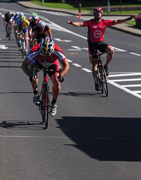 SPANGDAHLEM AIR BASE, Germany – Ronis Gutierrez, from U.S. Army Garrison Mannheim, raises his arms in celebration at the end of the annual United States Armed Forces in Europe classic bike race here Aug. 20. Krista Jones from Spangdahlem Air Base won the women’s 30-kilometer road race with a time of 1:03:49. Christopher Lulei, from Ramstein Air Base, Germany, won the men’s 50-kilometer road race with a time of 1:18:47. Twenty-six cyclists from nine different military installations participated in the road race. (U.S. Air Force photo/Airman 1st Class Matthew B. Fredericks)