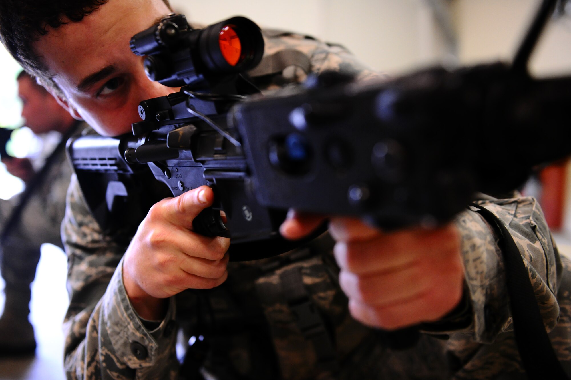 SPANGDAHLEM AIR BASE, Germany -- Airman 1st Class Alec Cox, 52nd Security Forces Squadron patrolman, aims down his sights during a “Shoot, Move, Communicate” training course here Aug. 22. The training teaches Airmen to react to a hostile shooter by using cover and effective communication to maneuver and engage the target. (U.S. Air Force photo/Staff Sgt. Nathanael Callon)