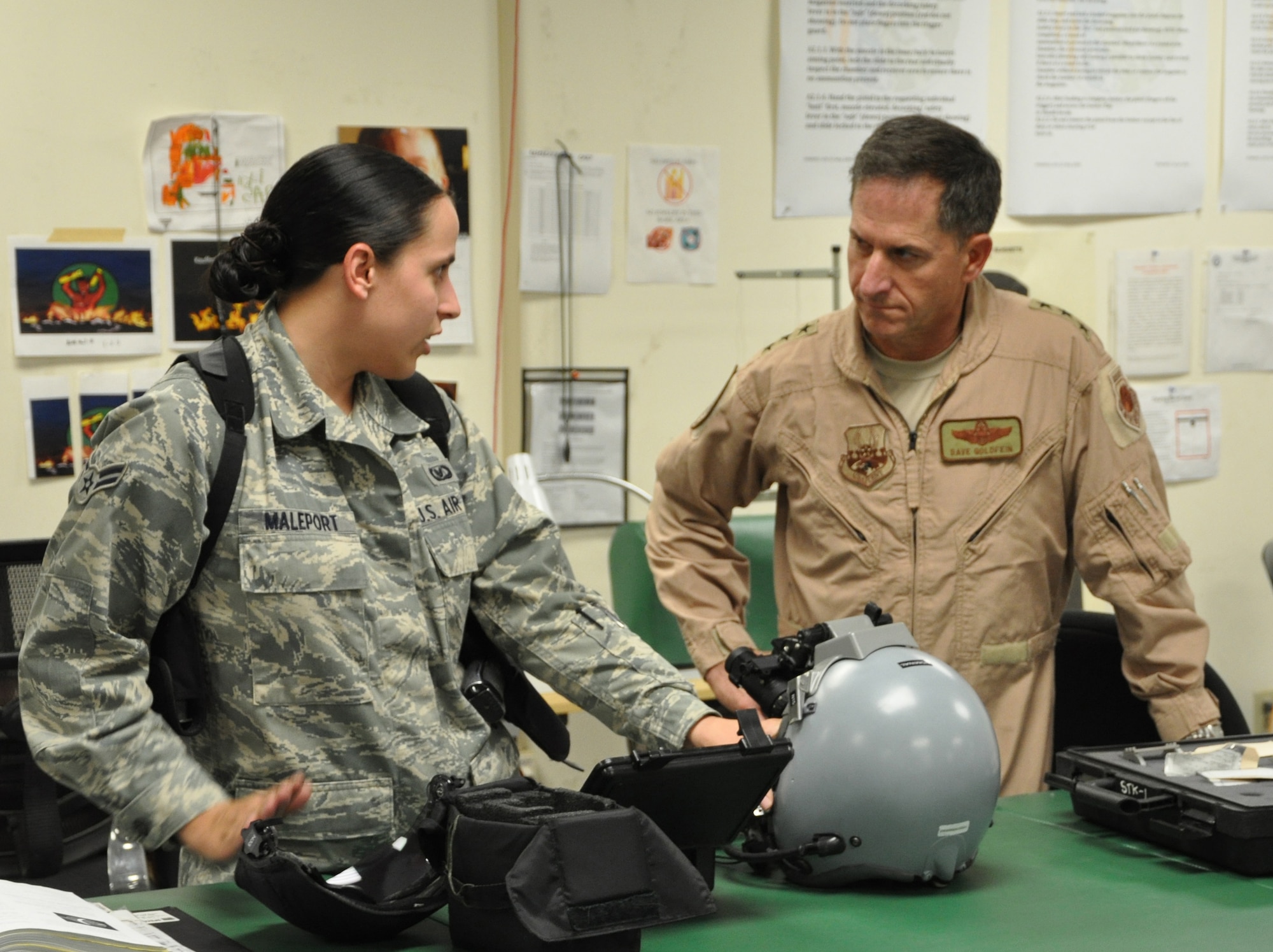 BAGRAM AIRFIELD, Afghanistan -- Airman 1st Class Courtney Maleport, 555th Expeditionary Fighter Squadron aircrew flight equipment journeyman, demonstrates a night vision goggle inspection to Lt. Gen. David Goldfein, commander of U.S. Air Forces Central Command, Aug. 21, 2011, during his tour of the U.S. Central Command area of responsibility. Maleport is a Virginia Beach, Va., native deployed from the 31st Operations Support Squadron at Aviano Air Base, Italy. (U.S. Air Force photo/Staff Sgt. John Wright) 
