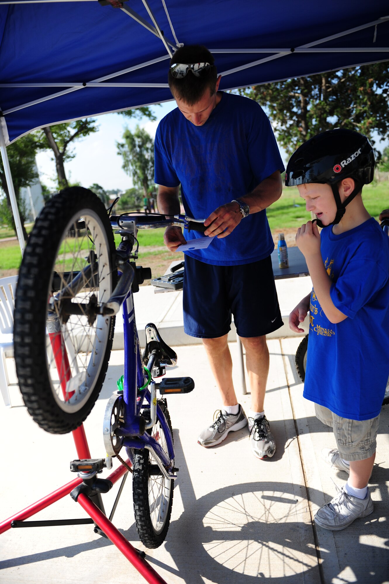 Jason Clute, 39th Air Base Wing Airmen and Family Readiness Center administrative assistant, reviews a bicycle inspection checklist during a Bicycle Safety Rodeo Aug. 20, 2011, at Incirlik Air Base, Turkey. Clute used the check list to inspect a bicycle’s tire pressure, wheel alignment and conduct brake checks among other items. (U.S. Air Force photo by Senior Airman Anthony Sanchelli/Released) 