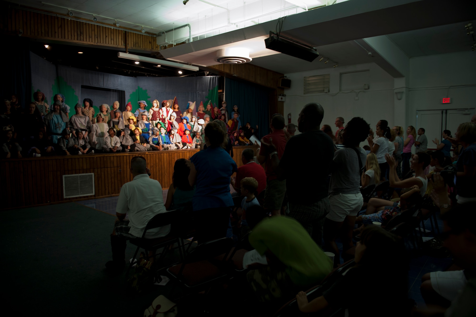 The audience cheers for the cast of "King Arthur's Quest" after a performance Aug. 20, 2011, at the community center at Incirlik Air Base, Turkey. Sixty-four children from the base participated in the play put on by the Missoula Children's Theatre. The theatre visits a variety of public venues to include most stateside and several overseas military installations to teach children about the performing arts. (U.S. Air Force photo by Tech. Sgt. Michael B. Keller/Released)