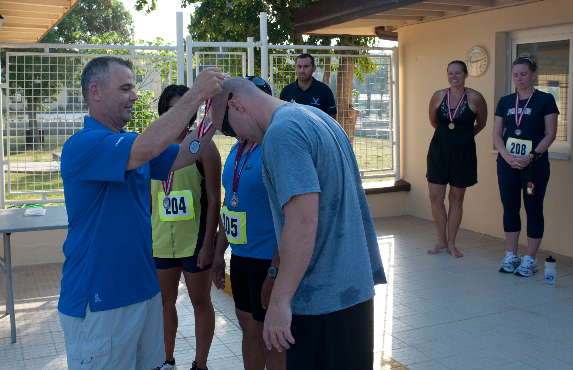 Col. Jeffrey Weed, 39th Air Base Wing vice commander, awards the second-place medal to Jason Williams, 39th Security Forces Squadron, and his team after the 3rd Annual Sprint Triathlon Aug. 20, 2011, at Incirlik Air Base, Turkey. The triathlon consisted of a five-kilomter run, 20-kilometer bike ride and a 225-meter swim. First place went to a 39th Force Support Squadron team consisting of Tom Ausherman, Shane Schmitt and Jason Livingston.(U.S. Air Force photo by Airman 1st Class Clayton Lenhardt/Released)