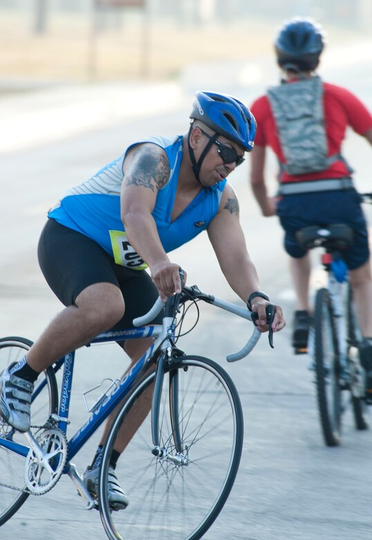 Francisco Morales, 39th Security Forces Squadron, turns to finish the 20-kilometer bike ride during the 3rd Annual Sprint Triathlon Aug. 20, 2011, at Incirlik Air Base, Turkey. The triathlon also included a five-kilometer run and a 225-meter swim.(U.S. Air Force photo by Airman 1st Class Clayton Lenhardt/Released)