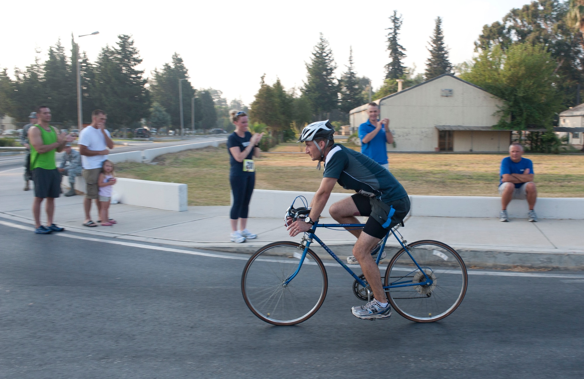 Observers cheer as Michael Gonzalez, 39th Civil Engineer Squadron, passes them during the 20-kilometer bike ride portion of the 3rd Annual Sprint Triathlon Aug. 20, 2011, at Incirlik Air Base, Turkey. The triathlon also included a five-kilometer run and a 225-meter swim.(U.S. Air Force photo by Airman 1st Class Clayton Lenhardt/Released)