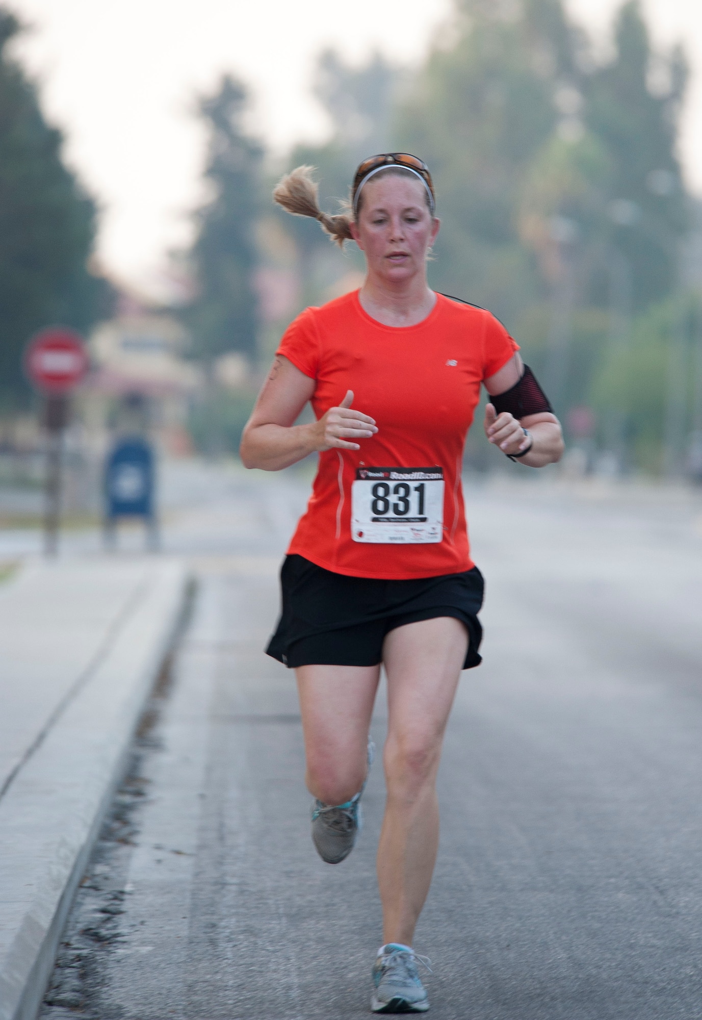 Traci Sarmiento, 39th Communications Squadron, finishes her five-kilometer run portion of the 3rd Annual Sprint Triathlon Aug. 20, 2011, at Incirlik Air Base, Turkey. The triathlon also included a 20-kilometer bike ride and a 225-meter swim.(U.S. Air Force photo by Airman 1st Class Clayton Lenhardt/Released)