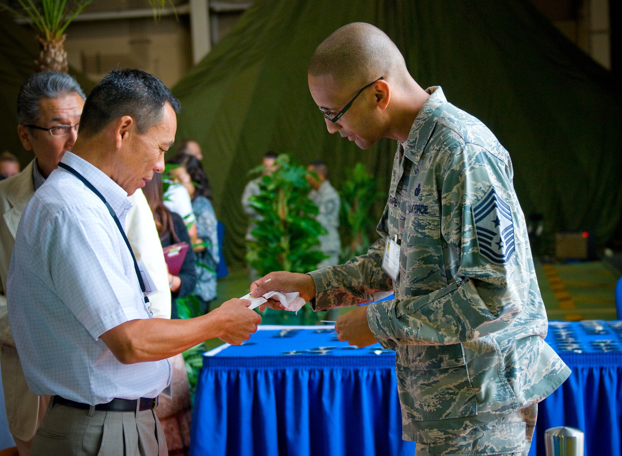 YOKOTA AIR BASE, Japan -- Chief Master Sgt. Ronald Draper, 374th Airlift Wing command chief master sergeant, greets a distinguished Japanese visitor during a luncheon held at the Japanese-American Friendship Festival at Yokota Air Base, Japan, Aug. 21, 2011. The 374th AW hosted the luncheon to give base leadership a chance to personally thank local dignitaries and reinforce good relations with the local community. (U.S. Air Force photo/Airman 1st Class Krystal M. Garrett)