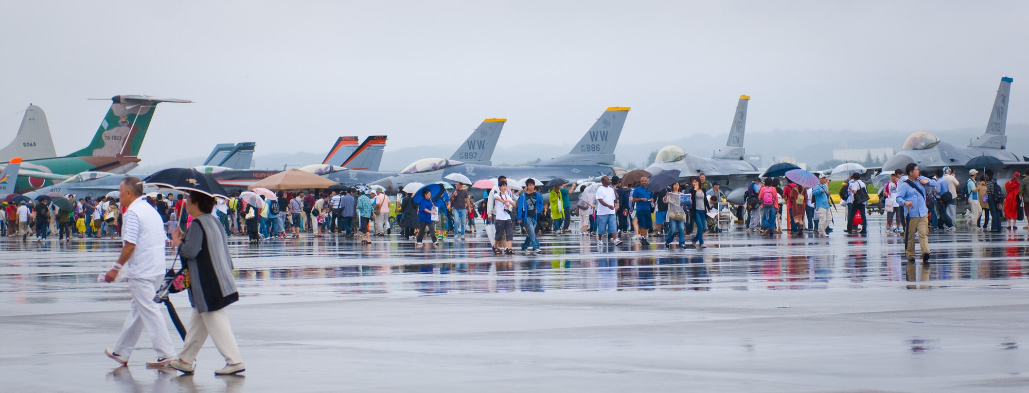 YOKOTA AIR BASE, Japan -- Visitors to the Japanese-American Friendship Festival view a wide variety of aircraft on display at Yokota Air Base, Japan, Aug. 21, 2011. The aircraft on display ranged from the U.S. Air Force's smallest fighter jets and helicopters to its largest cargo jets, and included aircraft from other services and nations as well. (U.S. Air Force photo/Airman 1st Class Krystal M. Garrett) 