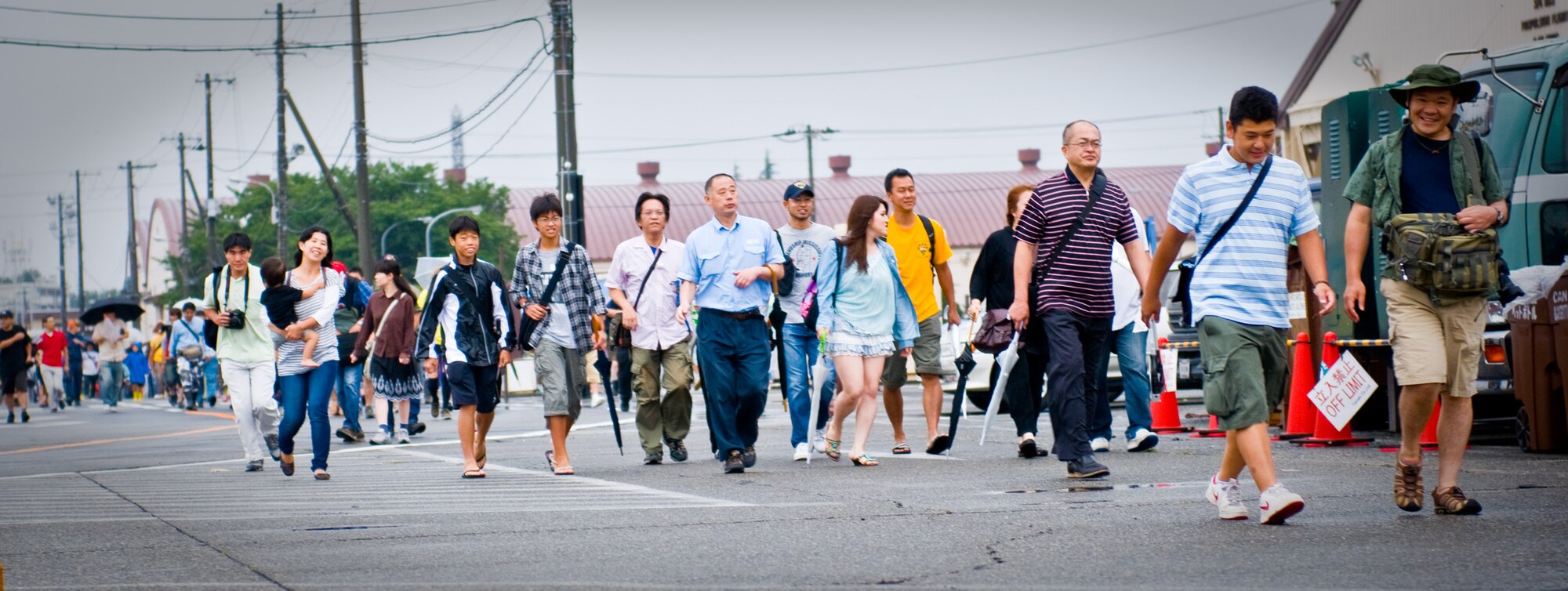 YOKOTA AIR BASE, Japan -- Visitors enter the Japanese-American Friendship Festival held at Yokota Air Base, Japan, Aug. 21, 2011. This two-day festival attracted approximately 117,000 visitors and offered a wide variety of American and Japanese entertainment, food and games. (U.S. Air Force photo/Airman 1st Class Krystal M. Garrett) 