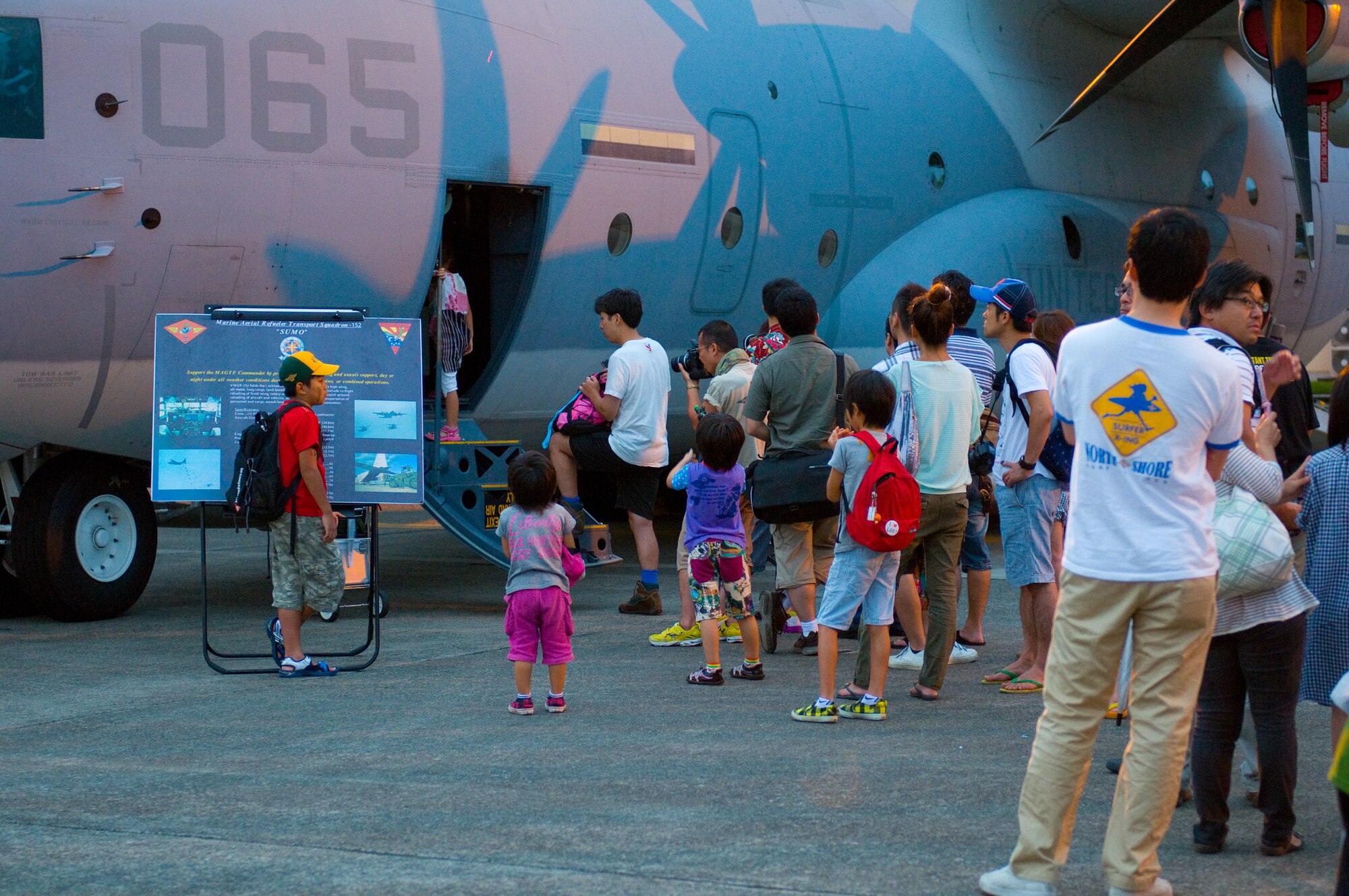 YOKOTA AIR BASE, Japan -- Guests attending the Japanese-American Friendship Festival wait to tour the cockpit of a C-130 Hercules aircraft at Yokota Air Base, Japan, Aug. 20, 2011. This two-day festival had a wide variety of aircraft on display, giving approximately 117,000 visitors a chance to explore them, inside and out. (U.S. Air Force photo/Airman 1st Class Krystal M. Garrett) 