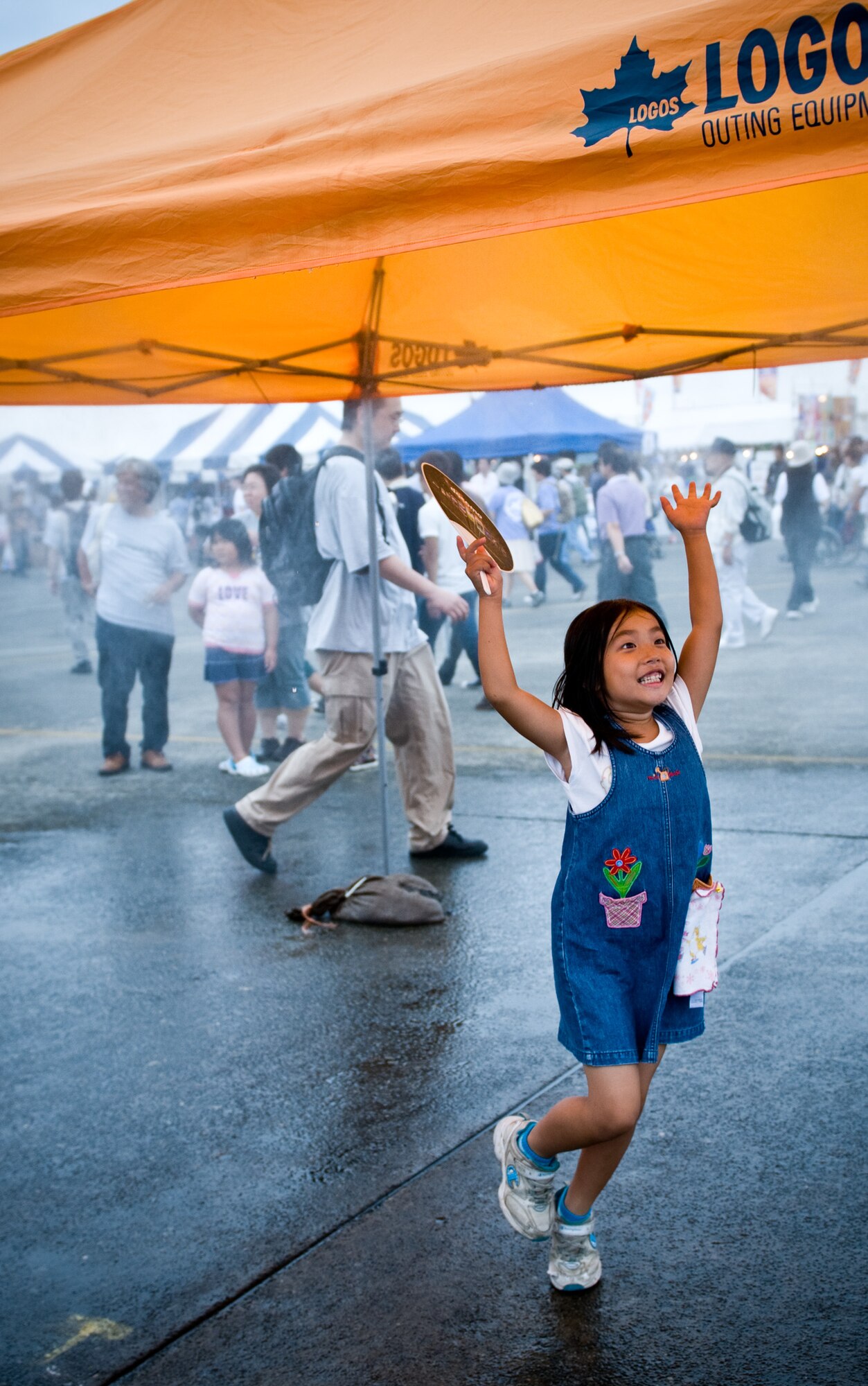 YOKOTA AIR BASE, Japan -- A Japanese child plays in a mist tent during the Japanese-American Friendship Festival held at Yokota Air Base, Japan, Aug. 20, 2011. Rain and cloudy weather conditions did little to deter the approximately 117, 000 visitors who attended the event. (U.S. Air Force photo/Airman 1st Class Krystal M. Garrett)