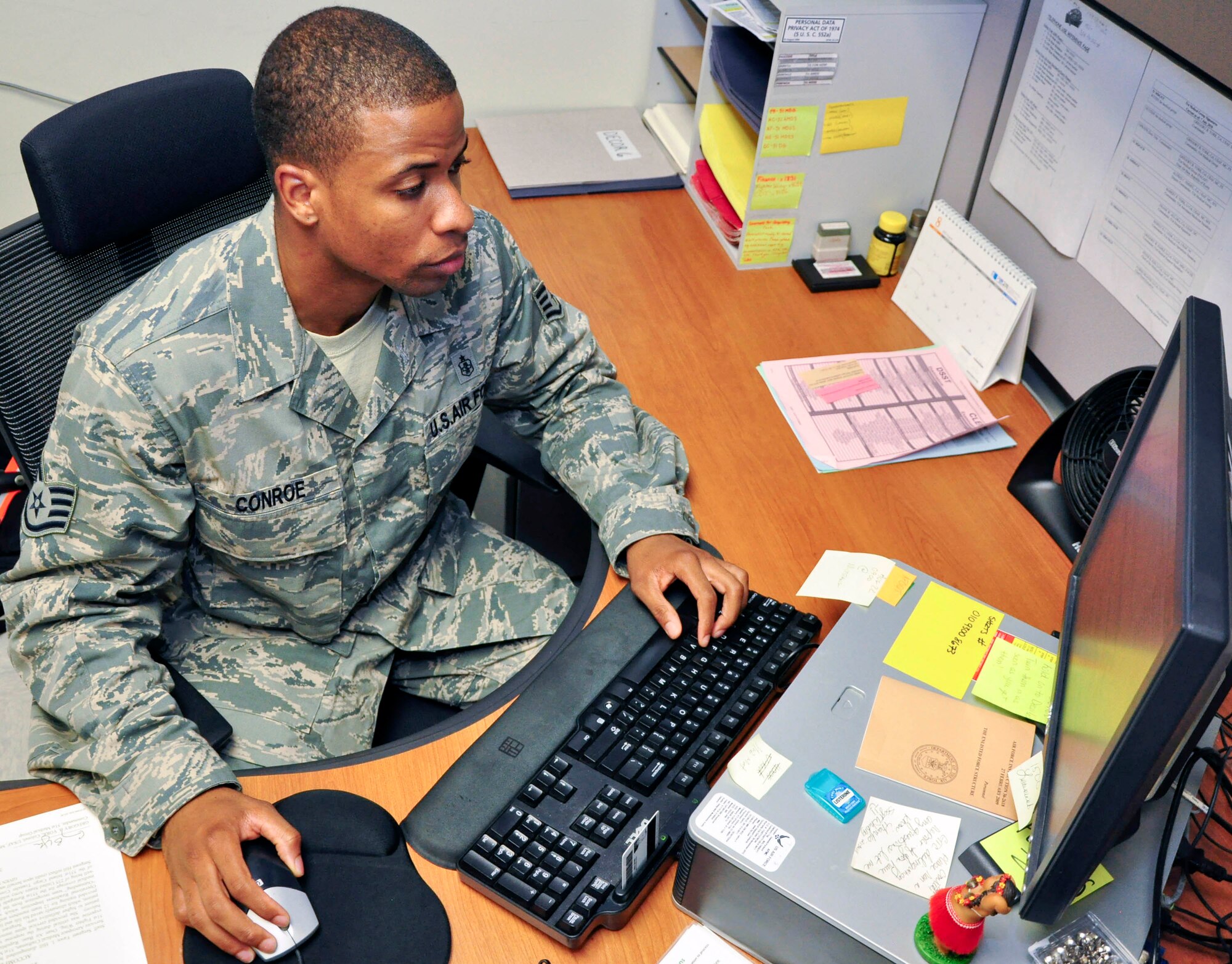 Staff Sgt. Hakim Conroe, 51st Medical Support Squadron, in-processes some paperwork through the 51st Medical Group Commander's Action Group office Aug. 17, 2011. Conroe was recently recognized for his hard work and dedication to his job through the Airman Spotlight program. (U.S. Air Force photo/Tech. Sgt. Chad Thompson)