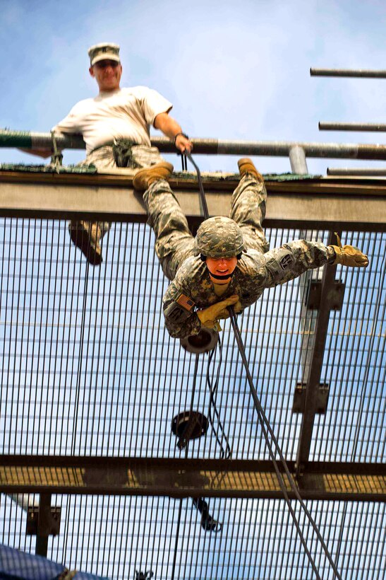 Army 1st Lt. Katie Elkins rappels down the rappel tower at the Joint Maneuver Training Center on Camp Atterbury, Ind., Aug. 18, 2011. Elkins is assigned to the Indiana National Guard's 81st Troop Command.