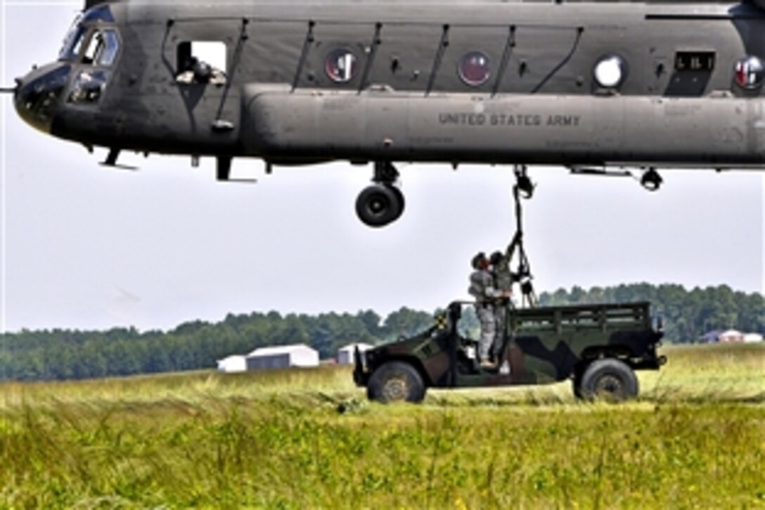 Army soldiers teach students sling load operations with a CH-47 Chinook helicopter at the 
Army Pathfinder School on Fort Pickett, Va., Aug. 19, 2011. The soldiers are assigned to the Fort Benning-based Warrior Training Center. The mission of a Pathfinder is to provide technical assistance and advise the ground unit commander on combat assault operations, sling load operations, air movement, airborne operations, and aerial re-supply by fixed and rotary wing aircraft.