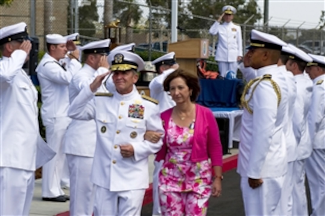 Navy Adm. Mike Mullen, standing rear, chairman of the Joint Chiefs of Staff, salutes as Navy Adm. Eric T. Olson and his wife, Marilyn, mark the end of his retirement ceremony at Naval Amphibious Base Coronado, Calif., Aug. 22, 2011. Olson concluded a 38-year career as a U.S. Navy SEAL, serving at every operational level in the special warfare community and commanding the U.S. Special Operations Command.