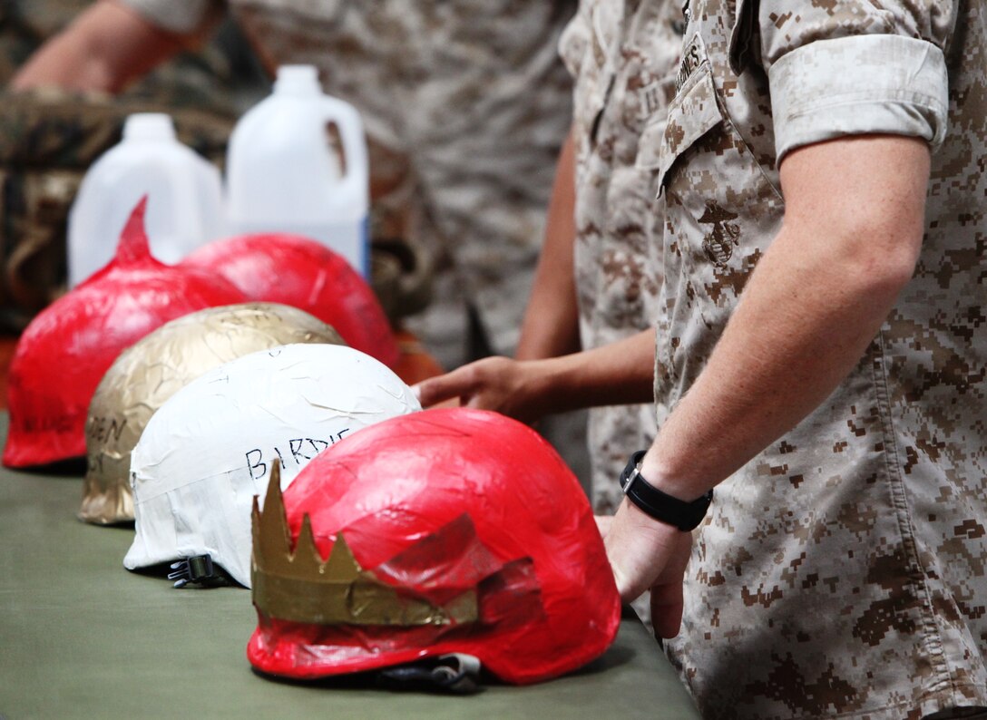 Marines from Air Delivery Platoon, Landing Support Company, Combat Logistics Regiment17, 1st Marine Logistics Group, prepare their gear before a jump at Camp Pendleton, Calif., Aug. 23. The helmets belong to the newest parachute riggers in the fleet.