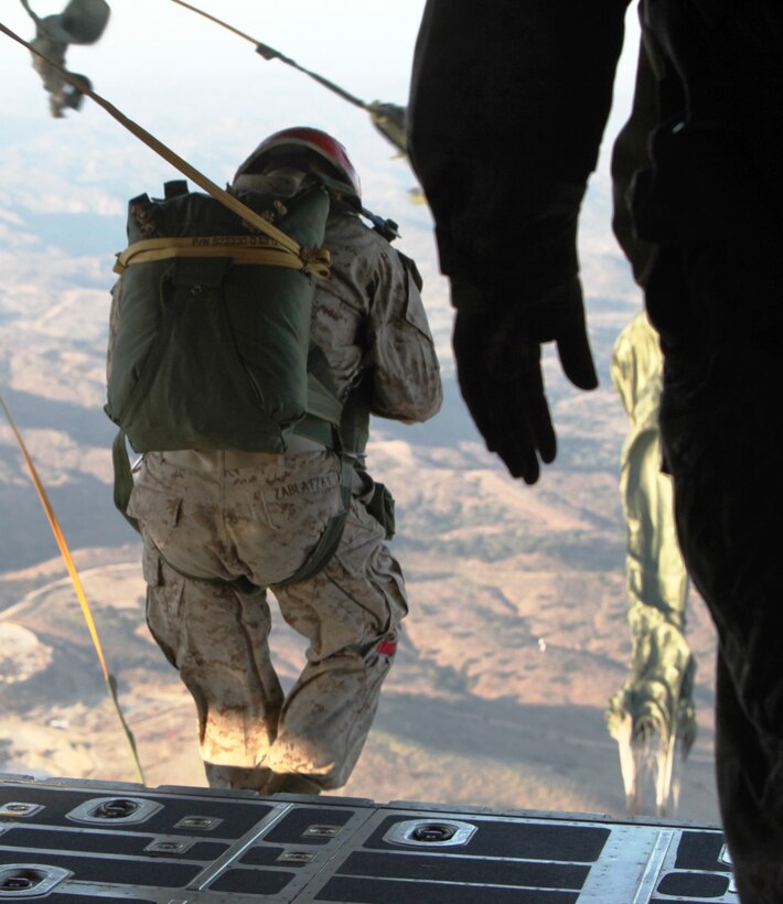 Pfc. William J. Zablatzky, a parachute rigger for Air Delivery Platoon, Landing Support Company, Combat Logistics Regiment 17, 1st Marine Logistics Group, jumps off the cargo bay hatch of a C-130 aircraft during a personnel jump over the hills of Camp Pendleton, Calif., Aug. 23. The primary purpose of the jump was to get jump masters qualified for operations.