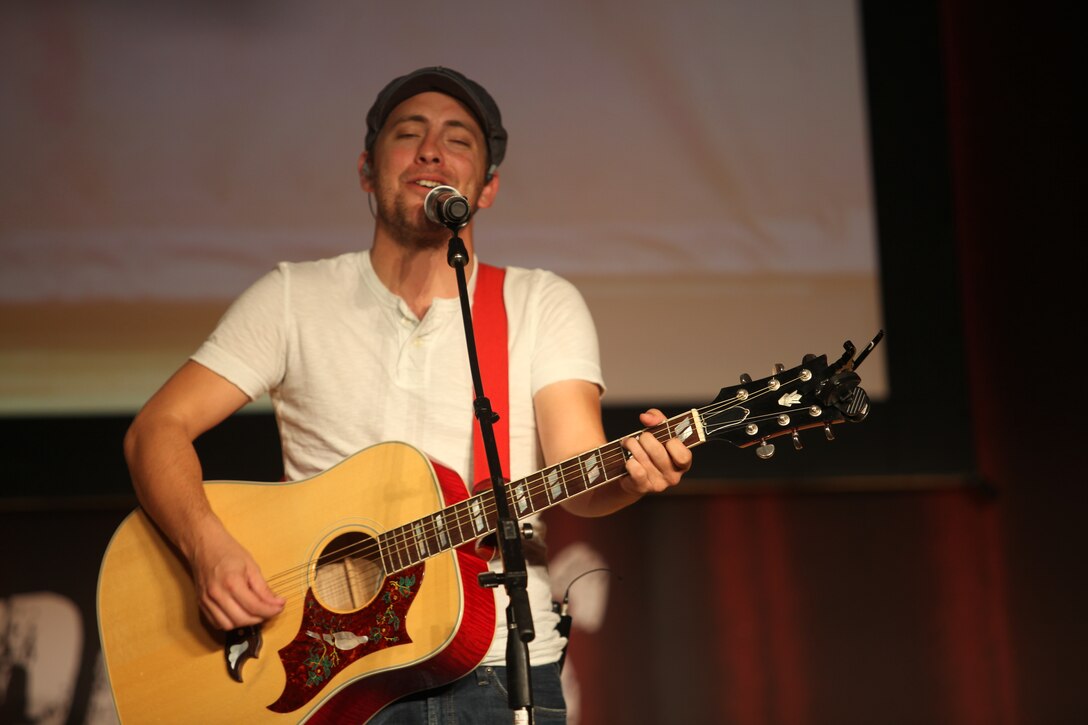 Tommy Stanley, an entertainer with the “Leatherneck Comedy and Entertainment Tour,” performs at the Base Theater aboard Marine Corps Base Camp Lejeune, Aug. 17. Stanley is a singer-songwriter currently serving in the Navy and was a “Top 10” contestant on NBC’s Nashville Star.