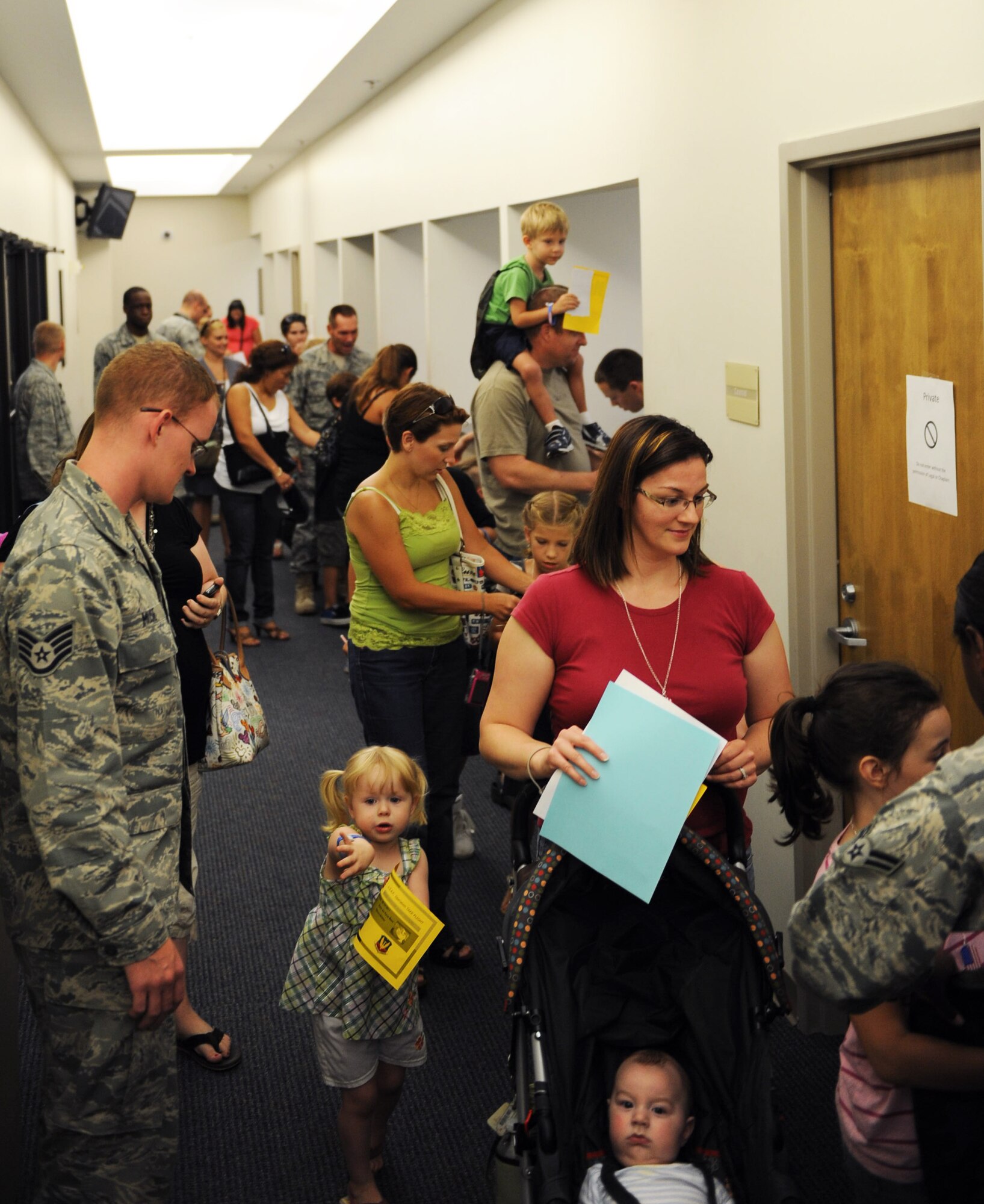 Children and parents process through the deployment line during the annual Operation Take-Flight at the deployment processing center on Shaw Air Force Base, S.C. Aug. 24, 2011. Operation Take-Flight gives children a chance to experience what processes their parents go through prior to deployments. (U.S. Air Force photo/Airman 1st Class Tabatha L. Duarte)(Released)