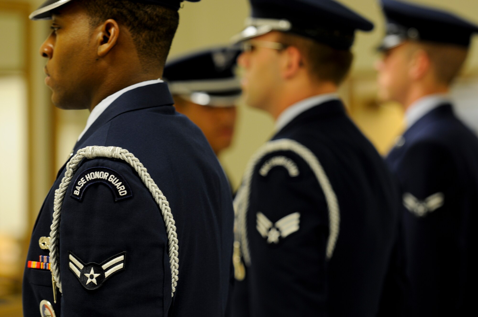 Kadena Honor Guardsmen stand at attention during an open ranks inspection preceding a memorial ceremony on Kadena Air Base, Japan, Aug. 22. There are key differences in the dress and appearance of guardsmen that’s easily distinguishable – silver piping on the legs and around the wrists, taps on the shoes, a “Base Honor Guard” patch just below the silver rope draped around the left shoulder, the Honor Guard badge and the blue “bus driver” cap bearing the Air Force insignia. (U.S. Air Force photo/Airman 1st Class Maeson L. Elleman)