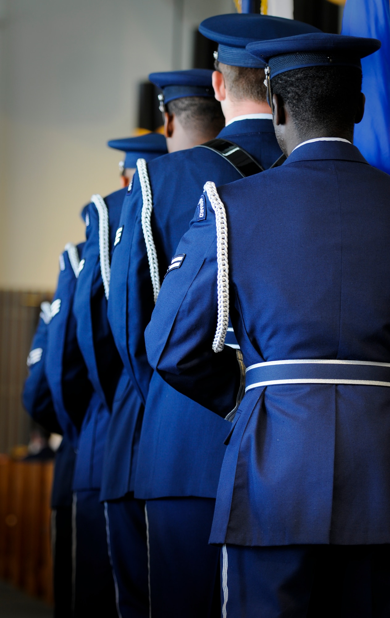 Kadena Honor Guardsmen prepare to march down the aisle of Kadena's Chapel One and present the colors during a memorial ceremony Aug. 22. With the motto “To Honor with Dignity” emblazoned on their badges, the guardsmen represent a perfectly polished personification of the word “pristine” while they do just that, whether at the joyous occasion of a change of command or retiring chief master sergeant, or the more solemn events like a memorial or funeral for a fallen service member. (U.S. Air Force photo/Airman 1st Class Maeson L. Elleman)