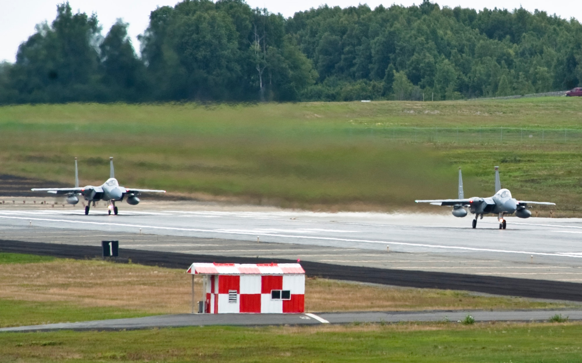 JOINT BASE ELMENDORF-RICHARDSON, Alaska -- Two F-15 Eagles sit at the end of JBER?s runway Aug. 18, waiting to take off. Approximately 150 Airmen and 10 jets from Kadena Air Base, Okinawa, Japan, traveled to Alaska earlier in the month to participate in Red Flag-Alaska 11-3, which runs from Aug. 15 through 26. (U.S. Air Force photo/Senior Airman Christopher Gross)