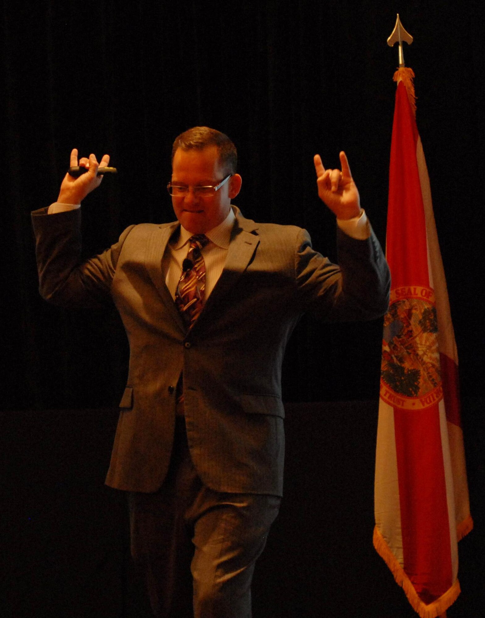 Mr. Chip Lutz, the keynote speaker at the Air Force Reserve Command’s South Region Yellow Ribbon Program event in Marco Island, tells the audience “You rock!” during his speech Aug. 20, 2011. Lutz, a retired Naval officer, gave attendees advice on getting through deployments and other tough times in life. (U.S. Air Force photo/Staff Sgt. Anna-Marie Wyant)  