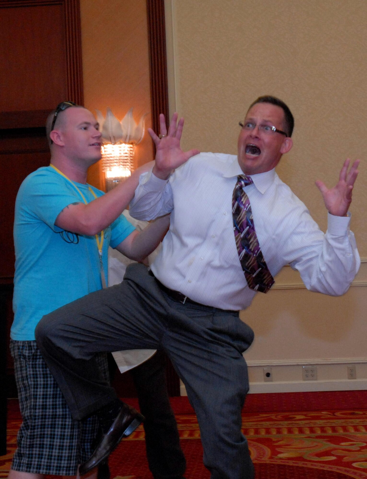 Mr. Chip Lutz, right, uses an audience member to help him act out a stressful situation during his breakout session, “R U Angry?” at Air Force Reserve Command’s South Region Yellow Ribbon Program event in Marco Island, Fla., Aug. 20, 2011. Lutz, a retired Naval officer, gave audience members tips on dealing with stress and anger during deployments and everyday life. (U.S. Air Force photo/Staff Sgt. Anna-Marie Wyant)
