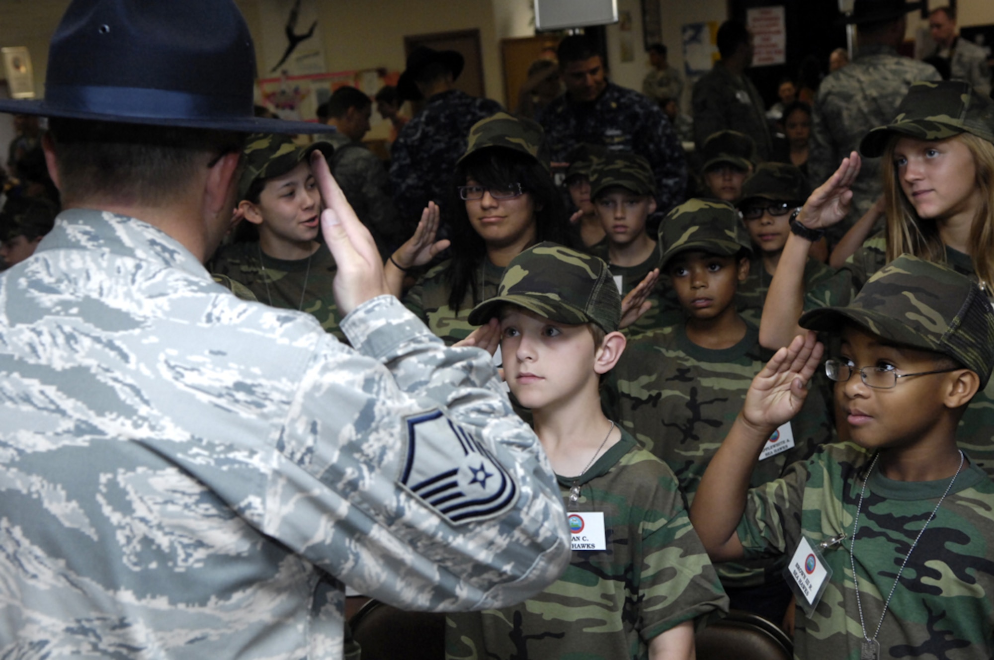 Children "enlist" during Operation Hele-On, a mock deployment for military families at Joint Base Pearl Harbor-Hickam, Hawaii, Aug 19. 155 children participated in the annual event, which included getting mobility bags and "gear" issued, getting bussed to the flight line, and a tour of the KC-135. This experience was geared to help children understand what their parents go through during a real military deployment. (U.S. Air Force photo/David D. Underwood, Jr.)
