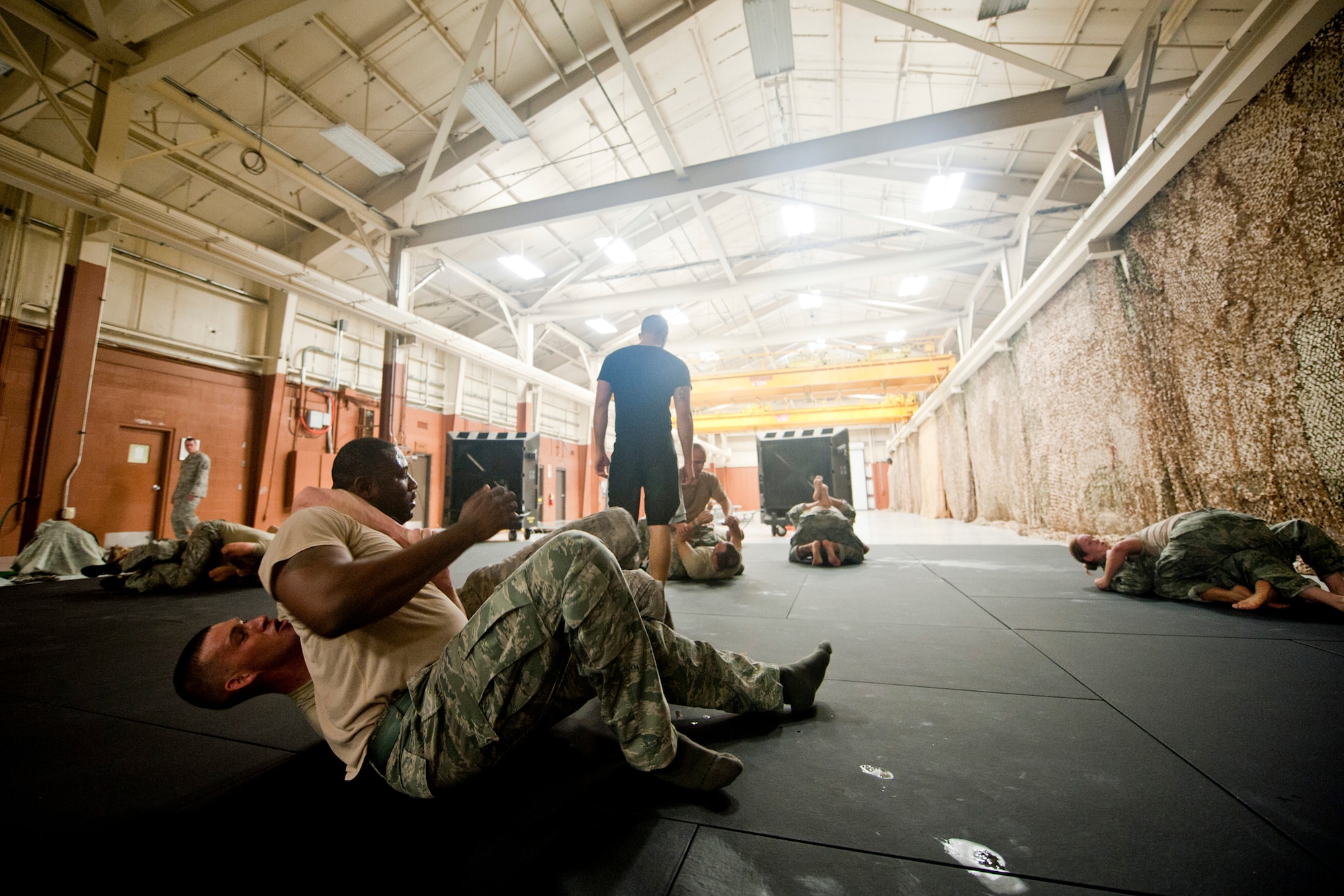 U.S. Air Force Staff Sgts. Vincent Just, 824th Base Defense Squadron, and Joshua Matz, 23rd Security Forces Squadron, battle for dominant position during an Air Force Combatives Instructor Course at Moody Air Force Base, Ga., Aug. 24, 2011. During the session, students practiced hand fighting and Brazilian Jiu-Jitsu  drills. (U.S. Air Force photo by Staff Sgt. Jamal D. Sutter/Released)