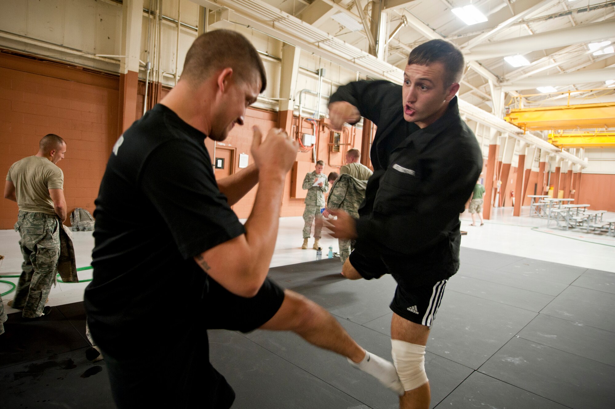 U.S. Air Force Staff Sgt. Dennis Seymour, 820th Combat Operations Squadron training instructor, left, and Senior Airman Bradley Akers, 824th Base Defense Squadron fireteam leader and course instructor, practice sparring during a break of the Air Force Combatives Instructor Course at Moody Air Force Base, Ga., Aug. 23, 2011. Seymour and Akers are two of four instructors teaching the five-day course. (U.S. Air Force photo by Staff Sgt. Jamal D. Sutter/Released)