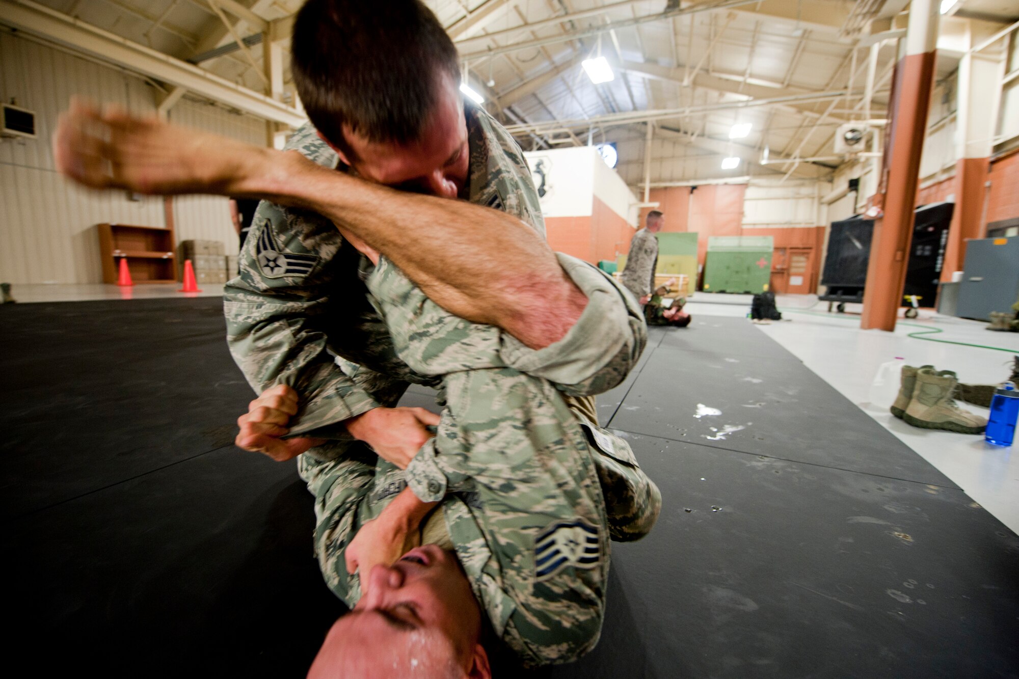 U.S. Air Force Senior Airman Douglas Lewis, 824th Base Defense Squadron, top, and Staff Sgt. Ronald Gazboda, 823rd Base Defense Squadron, battle for dominant position during an Air Force Combatives Instructor Course at Moody Air Force Base, Ga., Aug. 23, 2011. During the five-day course, students learn and train on a variety of stand-up and ground techniques they can use when in a combat situation. (U.S. Air Force photo by Staff Sgt. Jamal D. Sutter/Released)