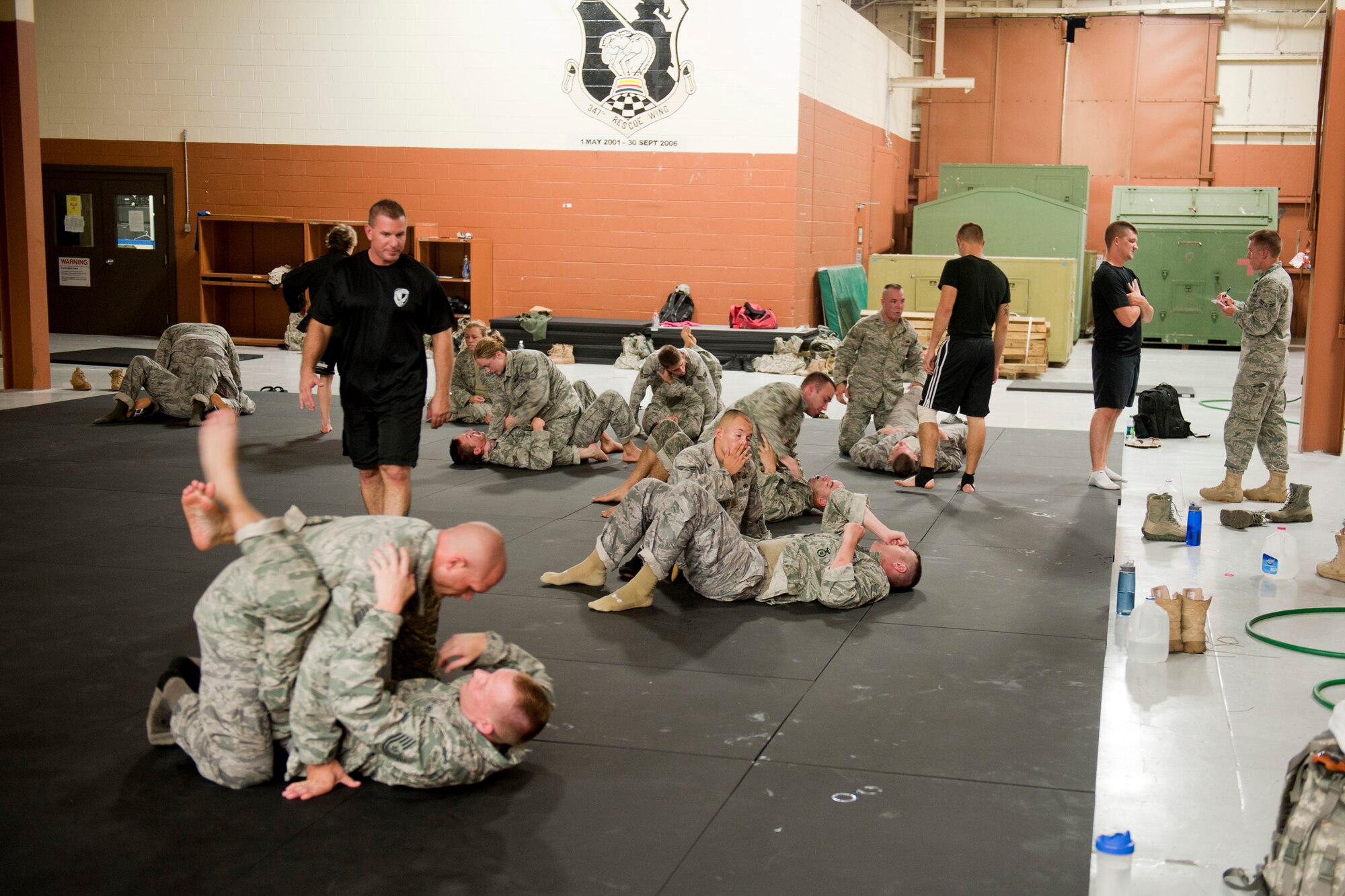 Students and instructors of an Air Force Combatives Instructor Course practice and evaluate grappling techniques at Moody Air Force Base, Ga., Aug. 23, 2011. The course is a 40-hour program that combines stand-up and ground techniques which Airmen can use when handling an opponent. Twenty-two Airmen from the 820th Base Defense Group and 23rd Security Forces Squadron participated in the course. (U.S. Air Force photo by Staff Sgt. Jamal D. Sutter/Released)