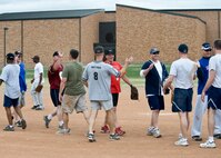 Players from the Chiefs and Eagles softball teams trade high fives and congratulate each other at the conclusion of the game during the base picnic at Ellsworth Air Force Base, S.D., Aug. 19, 2011. After several lead changes and nine long innings, the Chiefs pulled out the win. (U.S. Air Force photo/Airman Alystria Maurer/Released)