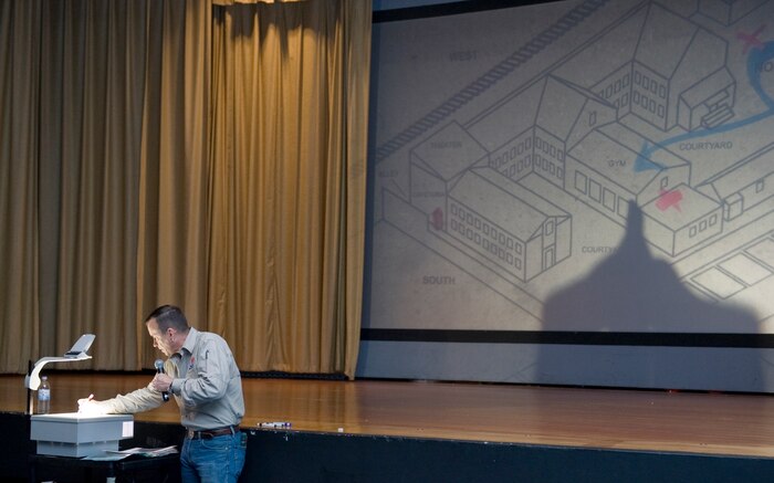 Retired U.S. Army Lt. Col. David Grossman presents his Bulletproof Mind lecture to approximately 150 Nellis Airmen Aug. 18, 2011, in the base theater at Nellis Air Force Base, Nev. Here, Grossman uses a map to describe a terrorist attack that occurred at a school in Beslan, Russia.  Grossman, author of "On Killing" and "On Combat," spoke to the Airmen about how external sources can negatively affect the minds of military personnel and what military personnel can do to "bulletproof" their minds against such adversaries. (U.S. Air Force photo by Senior Airman Stephanie Rubi/Released)