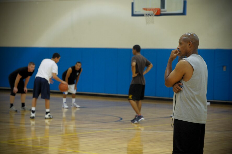 Trudell Hiller, head coach for the Moody Air Force Base varsity basketball team, watches as team hopefuls try out for the team. Hiller took a break from refereeing college-level basketball to coach the Moody team. (U.S. Air Force photo by Staff Sgt. Joshua J. Garcia/Released)