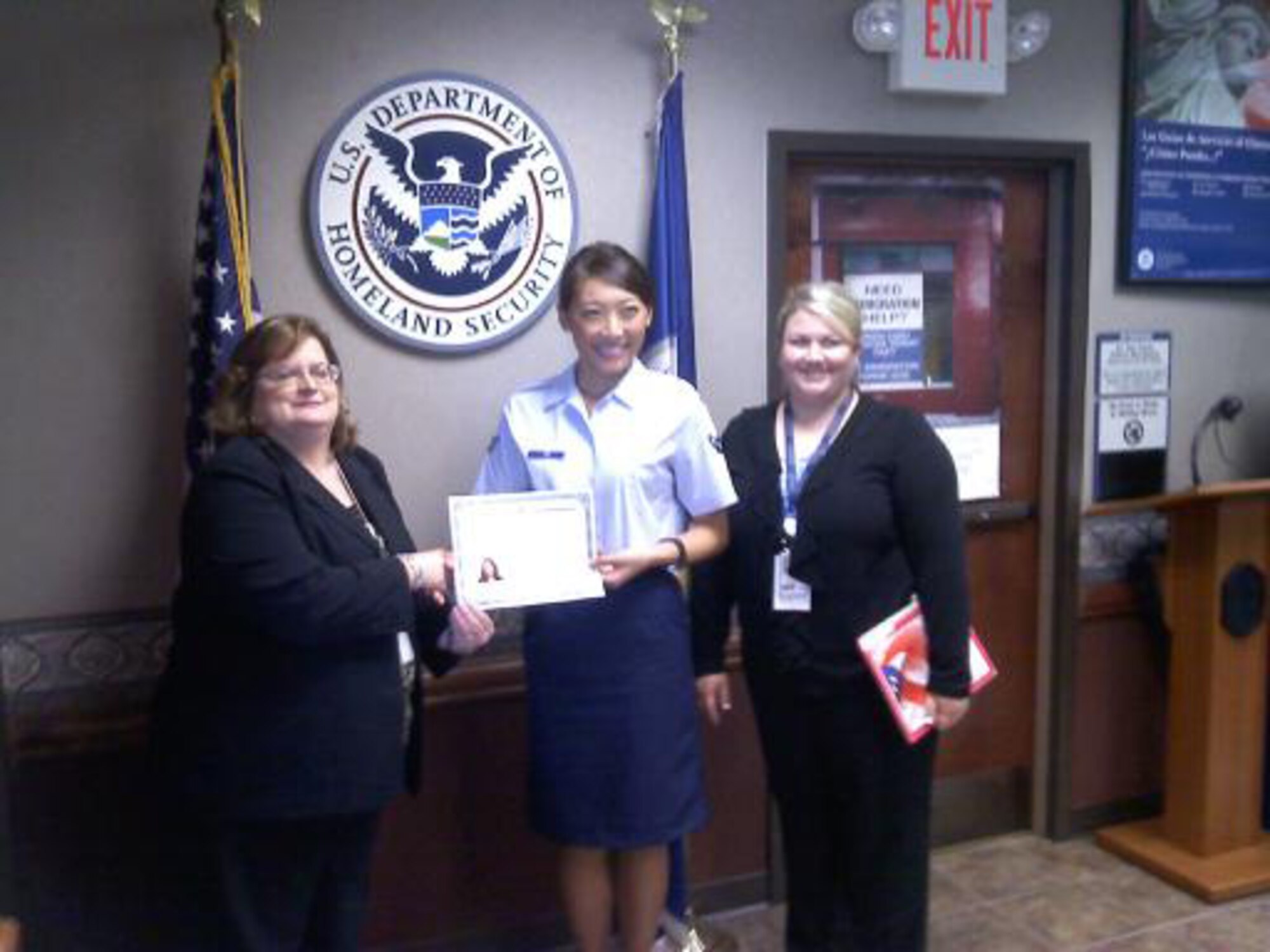 Airman Zhe “Kat” Tan poses for a photo while displaying her United States Certificate of Naturalization. Airman Tan, an information manager with the 188th Maintenance Operations Flight since June 2009, became a United States citizen Aug. 22, 2011. She relocated to the United States from Tian Jin, China, in 2004 and joined the 188th Fighter Wing five years later. (Courtesy photo)