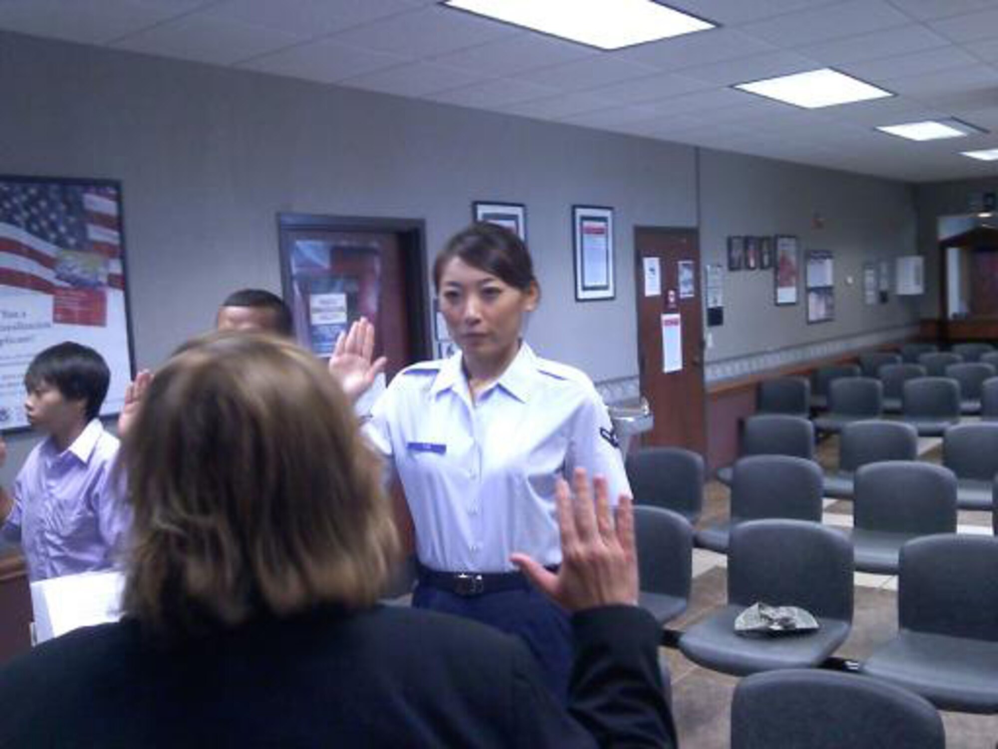 Airman Zhe “Kat” Tan receives her United States Certificate of Naturalization. Airman Tan, an information manager with the 188th Maintenance Operations Flight since June 2009, became a United States citizen Aug. 22, 2011. She relocated to the United States from Tian Jin, China, in 2004 and joined the 188th Fighter Wing five years later. (Courtesy photo)
