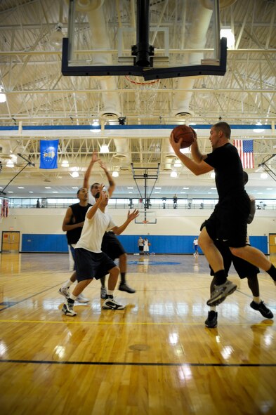 Team Moody members run offensive play drills during the Moody Air Force Base varsity basketball team tryouts at the Freedom I Fitness Center, Aug. 23, 2011. Members who make the team will compete in games against bases located in the southeastern United States as well as participate in tournaments. (U.S. Air Force photo by Staff Sgt. Joshua J. Garcia/Released)