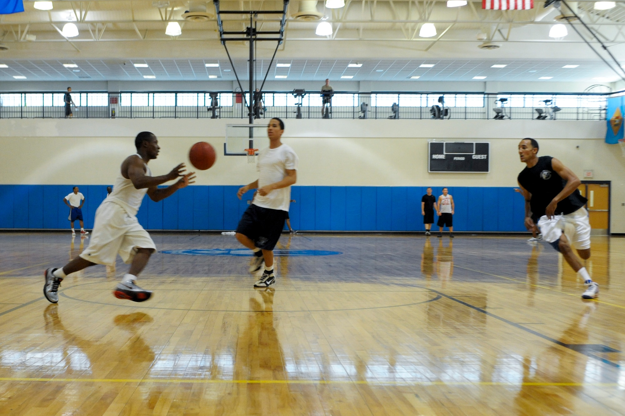 Team Moody members practice a training drill, the weave, during the Moody Air Force Base varsity basketball team tryouts at the Freedom I Fitness Center, Aug. 23, 2011. The weave trains players on the mechanics of passing while running the court. (U.S. Air Force photo by Staff Sgt. Joshua J. Garcia/Released)