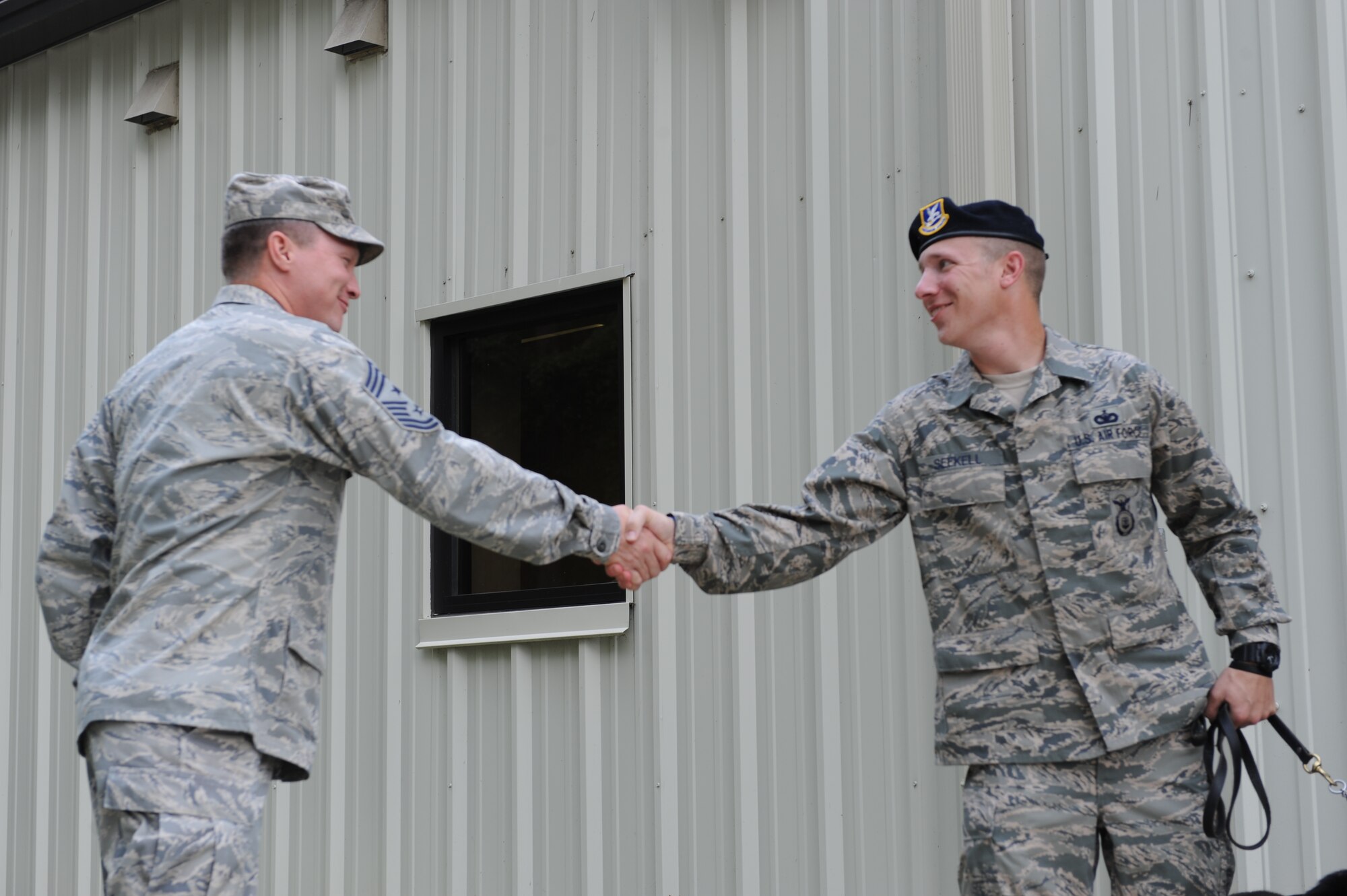 SEYMOUR JOHNSON AIR FORCE BASE, N.C. --  Command Chief Master Sgt. Blake Malpass greets Staff Sgt. Benjamin Seekell here Aug. 19,2011, as Seekell prepares to participate in the Security Forces 9/11 Ruck March to Remember hosted by the 4th Security Forces Squadron.  Seekell is a military working dog handler with the 4th SFS and lost his left foot when he stepped on a landmine outside Bagram Airfield, Afghanistan, in early May.   (U.S. Air Force Photo by 2nd Lt. Keavy Rake/Released)