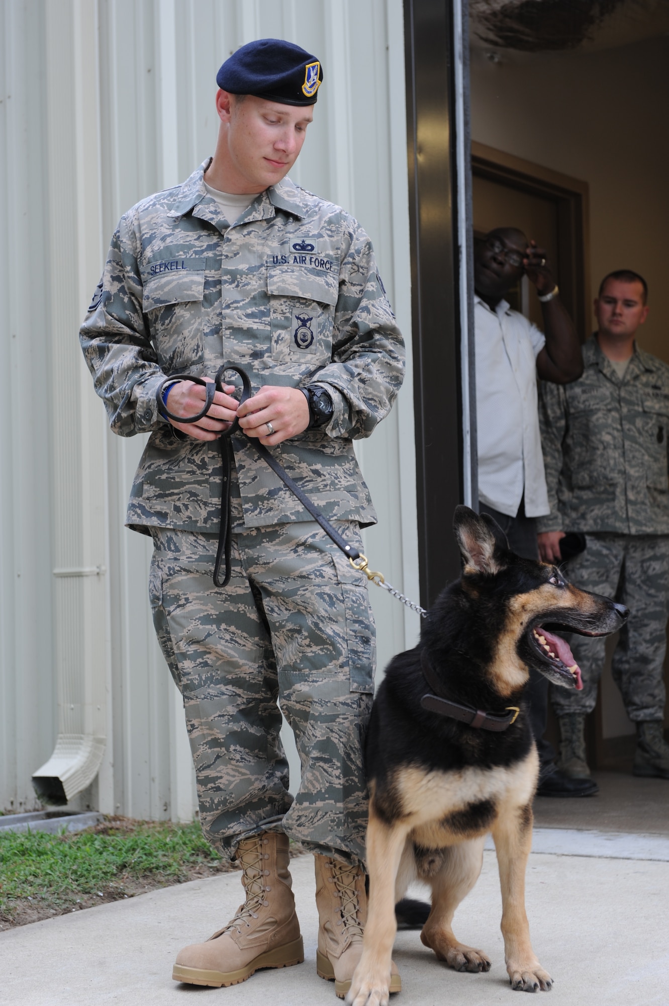 SEYMOUR JOHNSON AIR FORCE BASE, N.C.—Staff Sgt. Benjamin Seekell visits his military working dog Charlie here Aug. 19, 2011.  Seekell and Charlie were injured by a landmine outside Bagram Airfield, Afghanistan in early May while on patrol.  Seekell is a military working dog handler with the 4th Security Forces Squadron.  Members of the 4th SFS brought Charlie to visit Seekell during his recovery at Walter Reed Medical Center in Washington, D.C.   Seekell is a native of Charlestown, R.I.  (U.S. Air Force photo by 2nd Lt. Keavy Rake/Released)