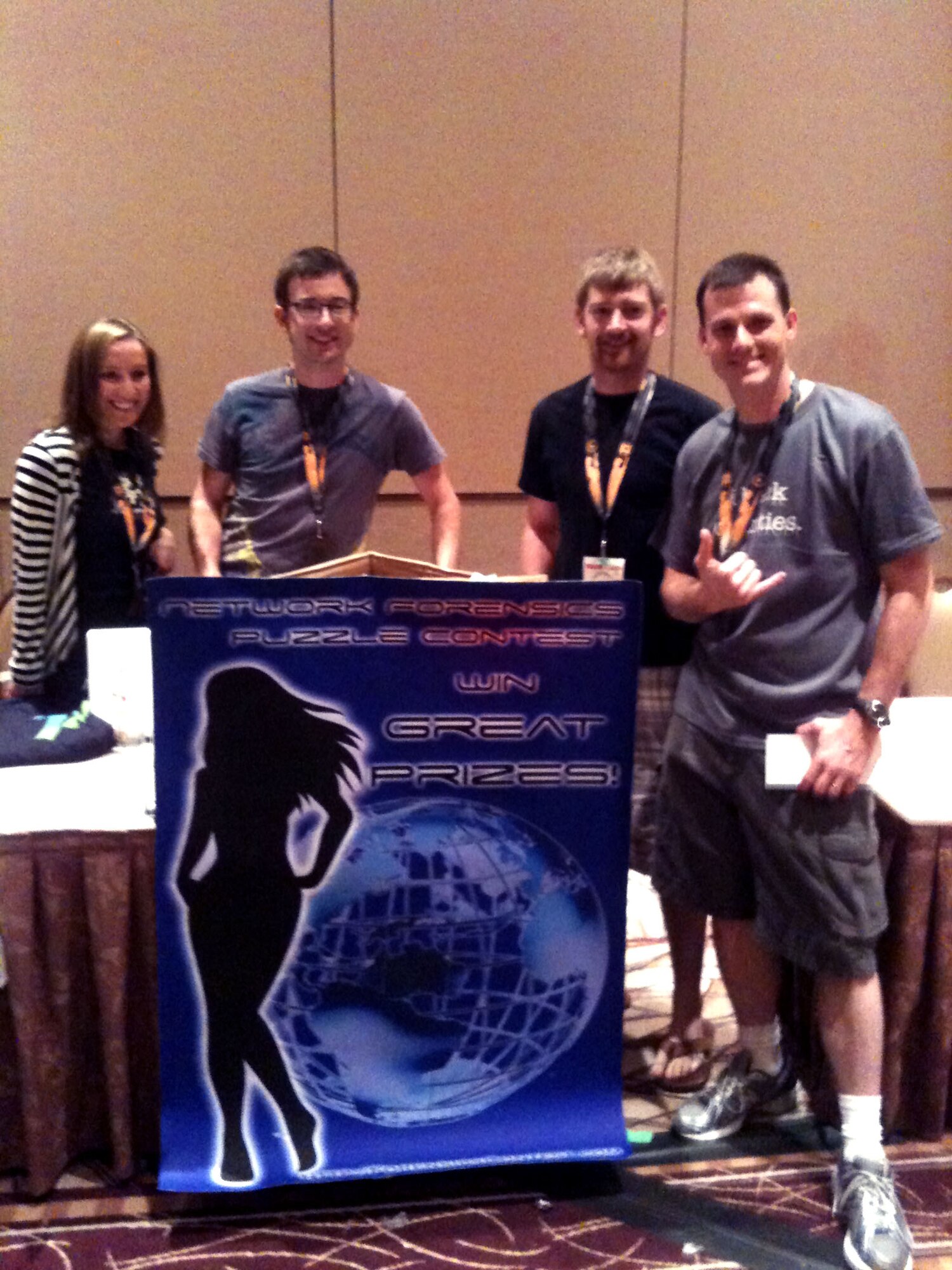Special Agent Kyle McCracken, right, accepts the second place award in the network forensics contest on behalf of the OSI cyber team at the DEF CON 19 conference. There were several contests during the conference, including lock-picking, art, slogan, scavenger hunt, capture the flag and network forensics. (U.S. Air Force photo courtesy of SA Kyle McCracken.)