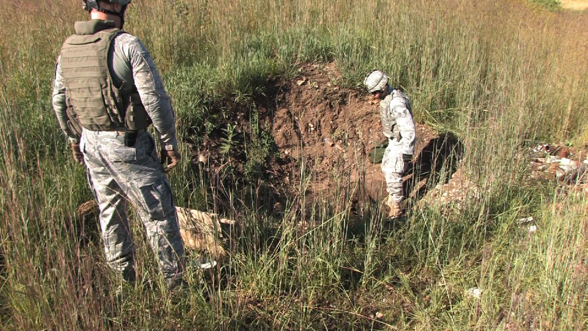 Master Sgt. Scott Castleman, Explosive Ordnance Disposal superintendent and Staff Sgt. Nathan Lentsch, EOD craftsman responded to Camp Ripley Aut. 17 to dispose of a 122mm projectile mortar round that failed to explode.  They safely detonated the device rendering it harmless. (Air Force Photo/Wendy Cormier)