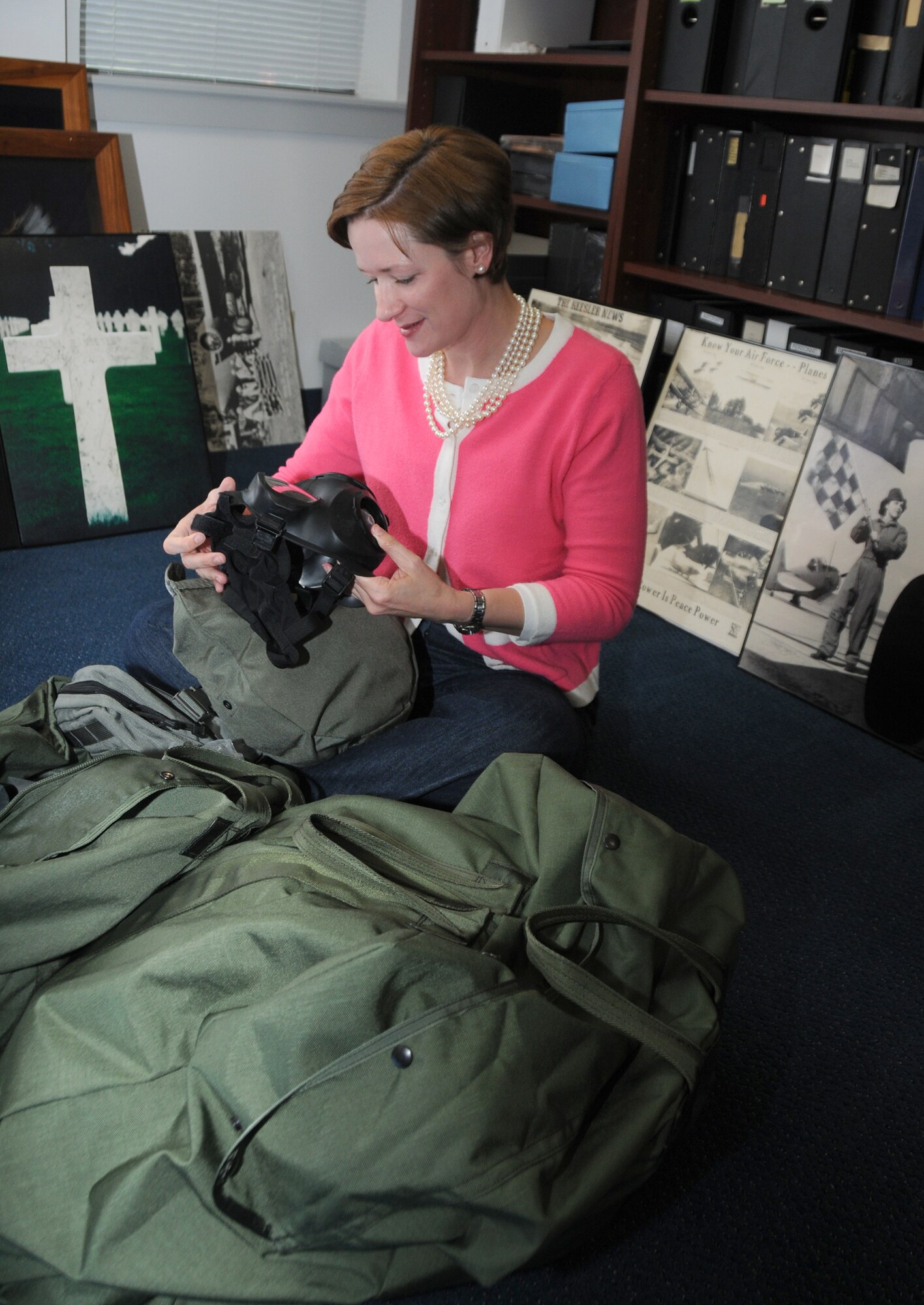 Dr. Susan Dawson, 81st Training Wing historian, checks out her gas mask as she goes through her deployment duffle bags in her office in wing headquarters in preparation for a four-month assignment to Southwest Asia.  (U.S. Air Force photo by Kemberly Groue)