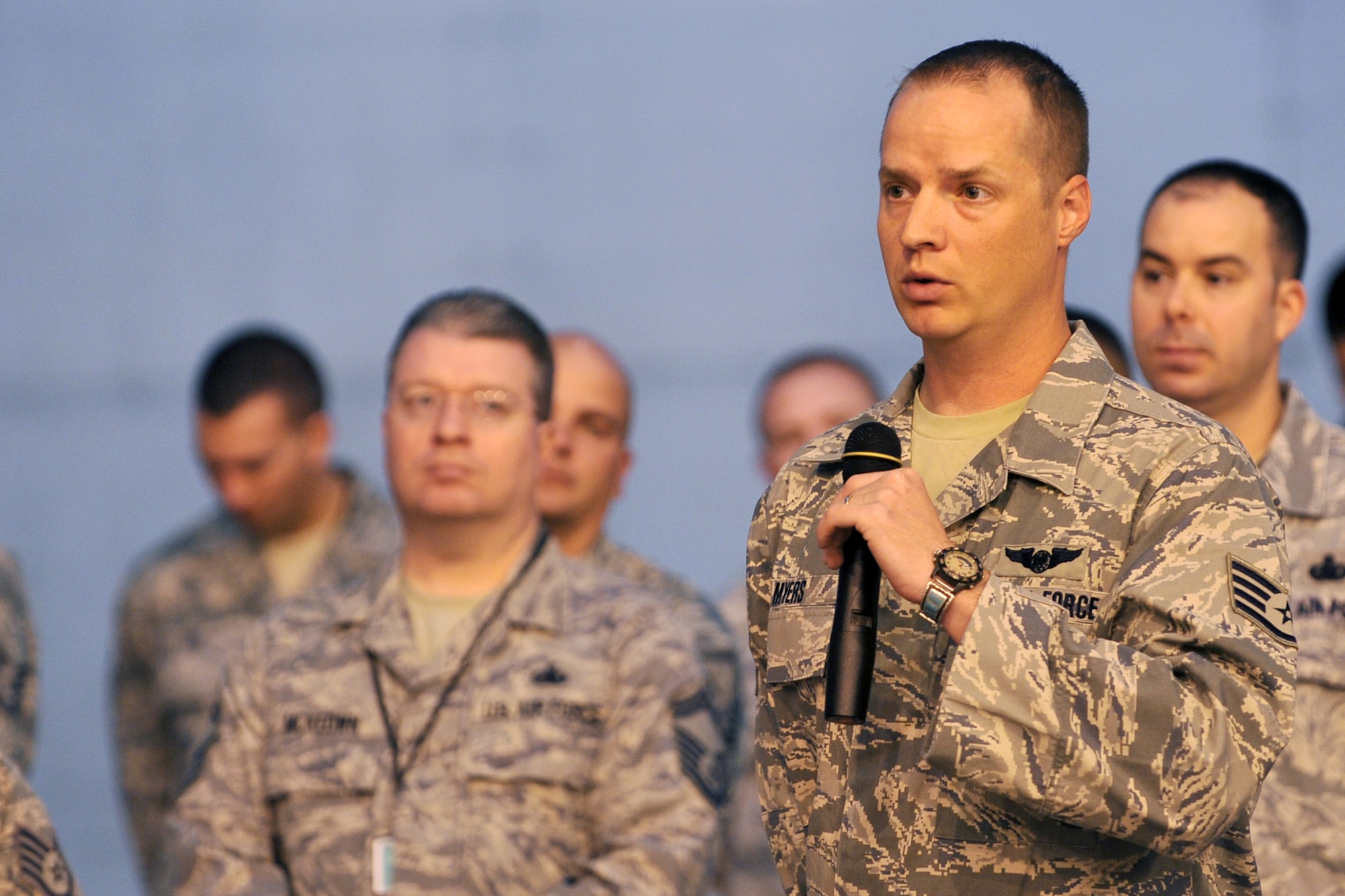 U.S. Air Force Staff Sgt. Dale Myers, with the 97th Intelligence Squadron, asks Chief Master Sgt. of the Air Force James Roy a question during an enlisted call inside the Bennie Davis Maintenance Facility at Offutt Air Force Base, Neb., Aug. 19. Roy took time while he was here to dispel rumors and explain what Airmen can look for on the horizon. (U.S. Air Force Photo by Charles Haymond)